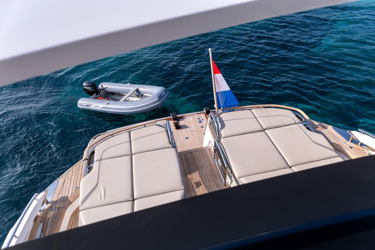 Luxury Princess S78 yacht deck with sun loungers and tender boat, 2019 model.