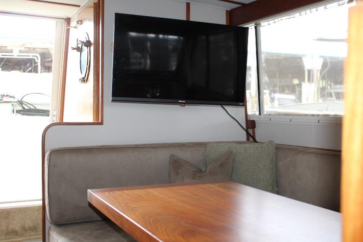 Interior of 1988 Tollycraft 30 Sport Cruiser with TV and dining area.
