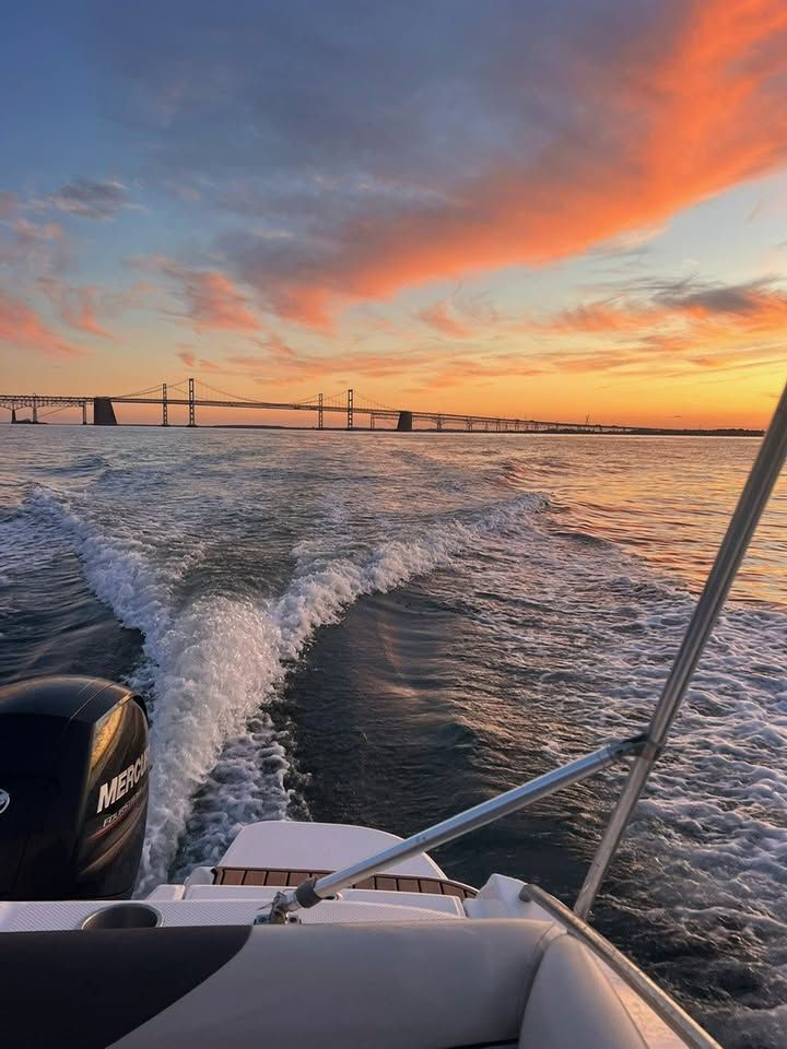 2018 Bayliner 210 Deck Boat on the water at sunset.