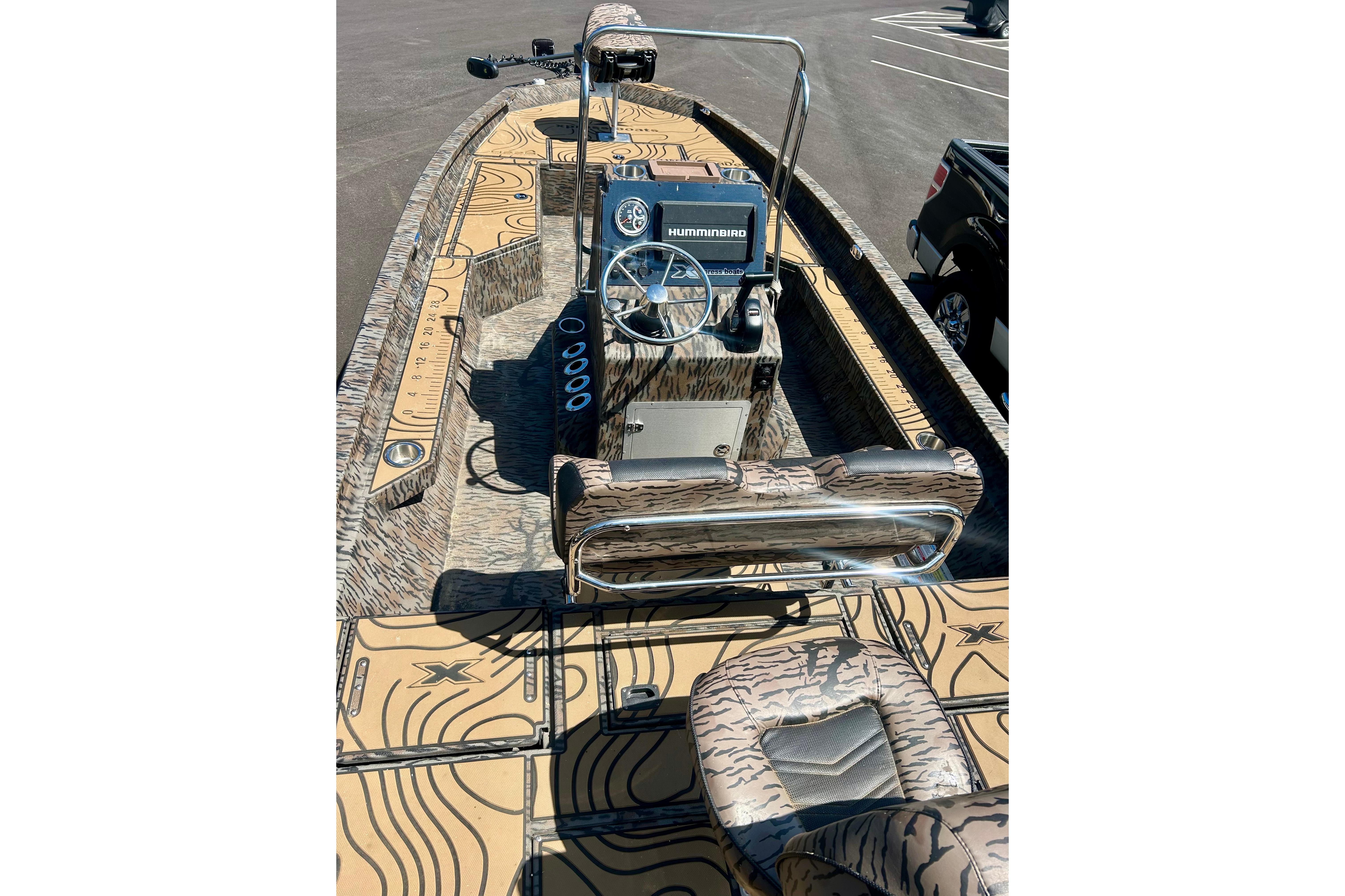 2025 Xpress H22B Bay boat interior with camouflage design and modern steering console.