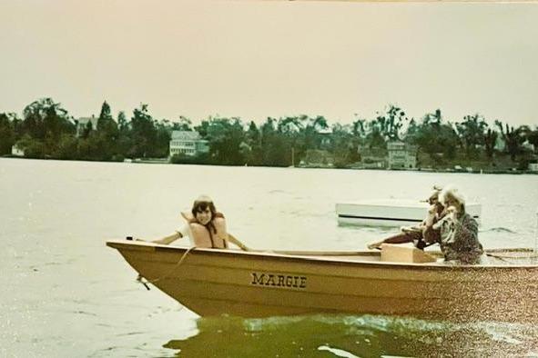 1968 John Dory Center Console boat named "Margie" on a lake with passengers.