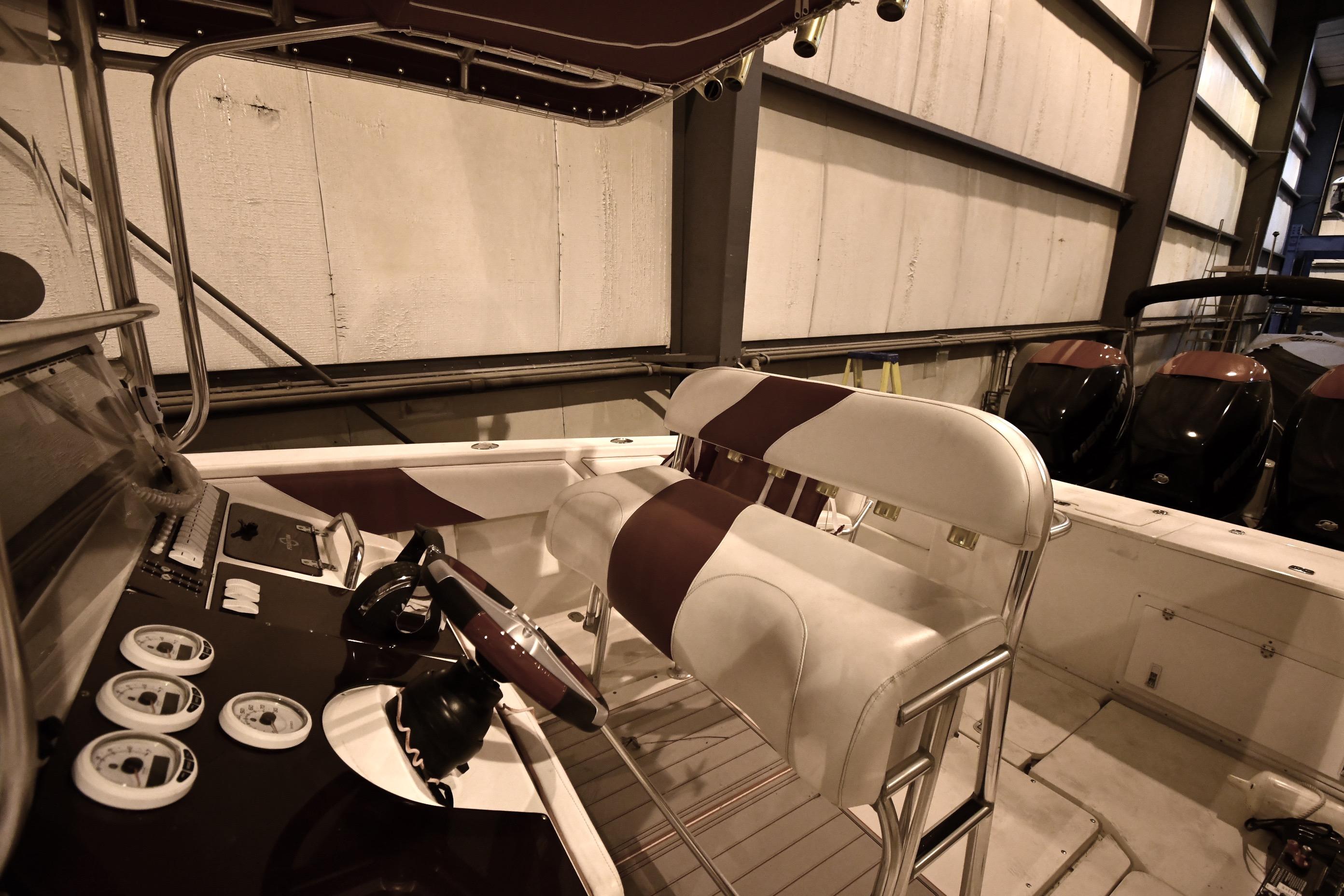 2001 Fountain 38 Center Console boat interior with steering wheel and seating.
