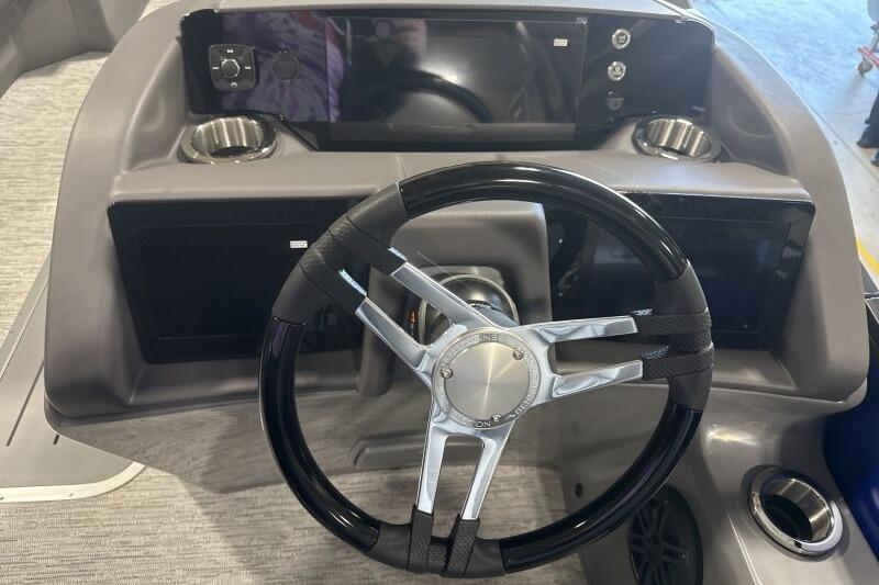 Steering console of 2026 Bennington 23 LXS Swingback with modern controls and cup holders.
