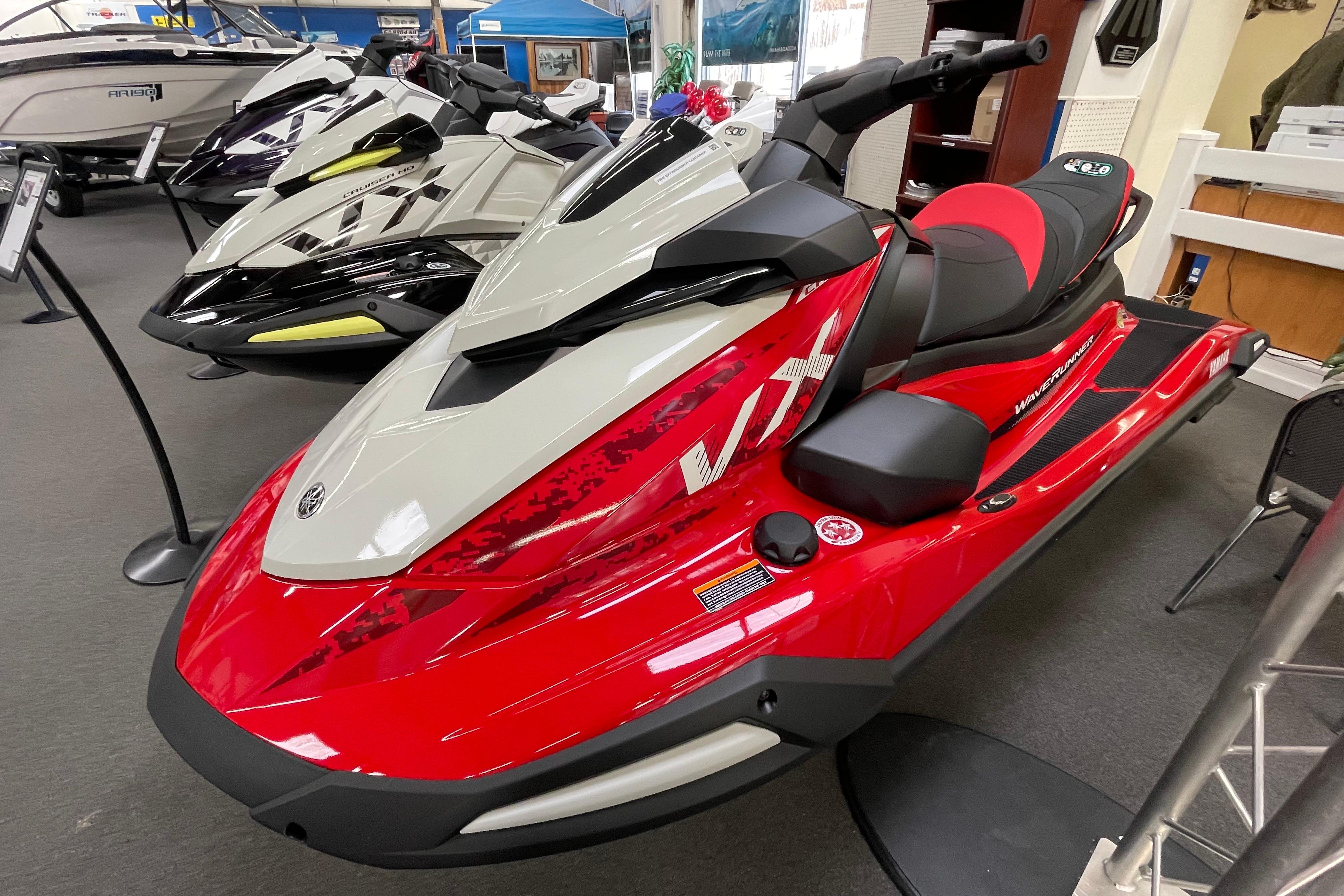 2026 Yamaha WaveRunner VX Cruiser in showroom, red and white design, sleek and modern.