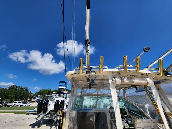 2005 Pursuit 3070 Offshore Center Console boat under clear blue sky.