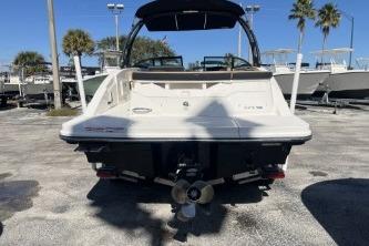 2024 Sea Ray SPX 230 boat rear view in a sunny marina setting.