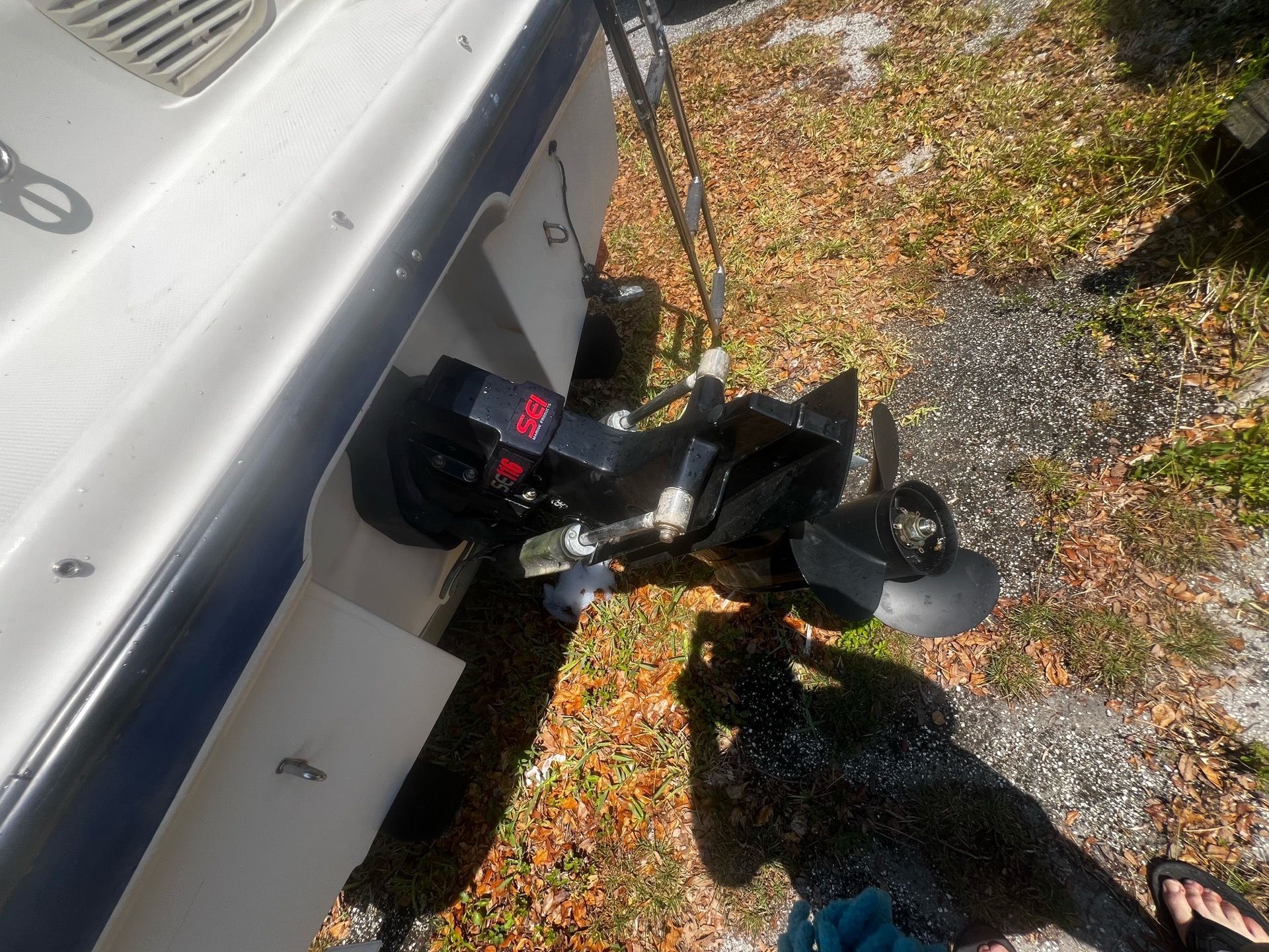 Close-up of a Bayliner 185 outboard motor on dry ground.