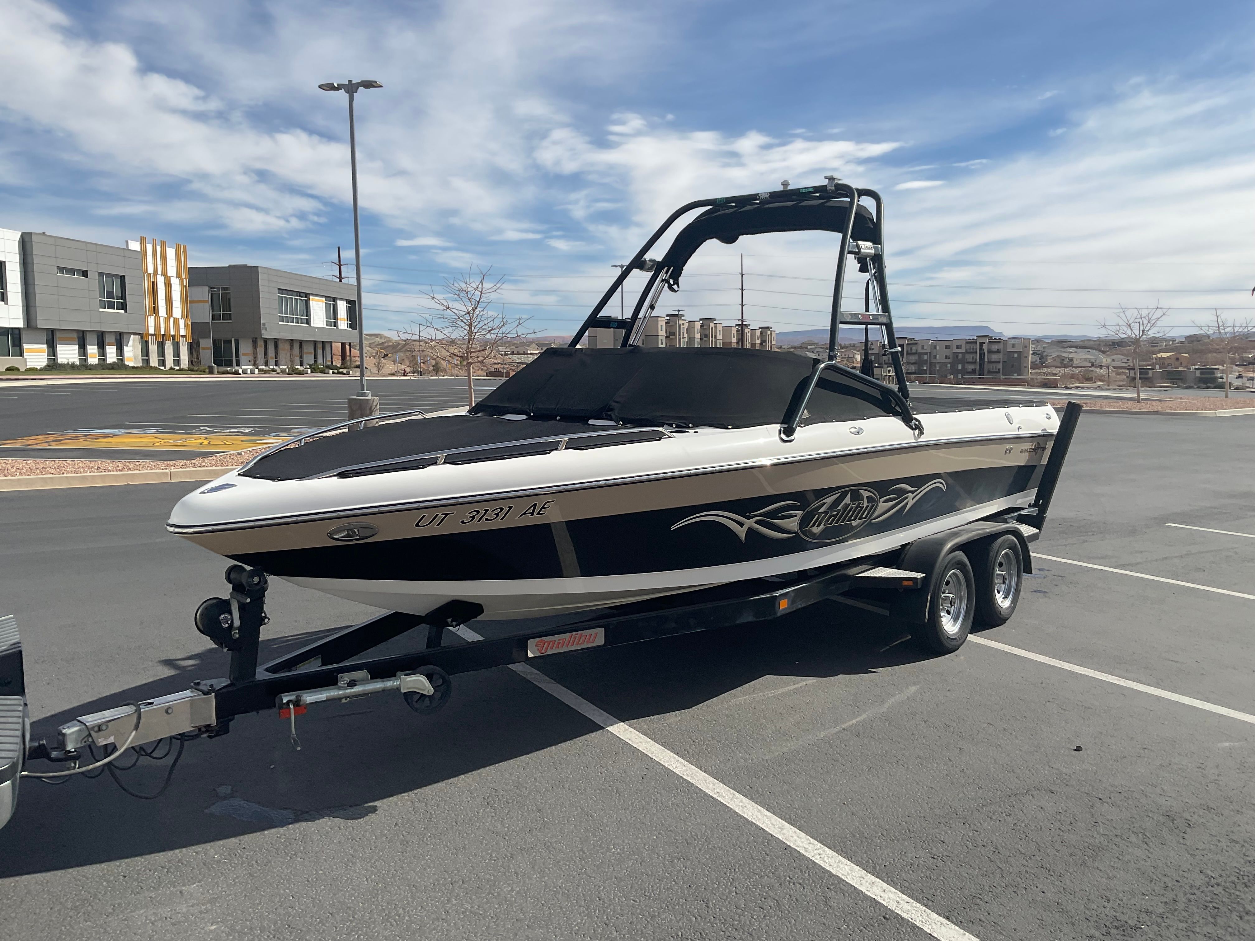 2003 Malibu Wakesetter 23 LSV on a trailer in a parking lot.
