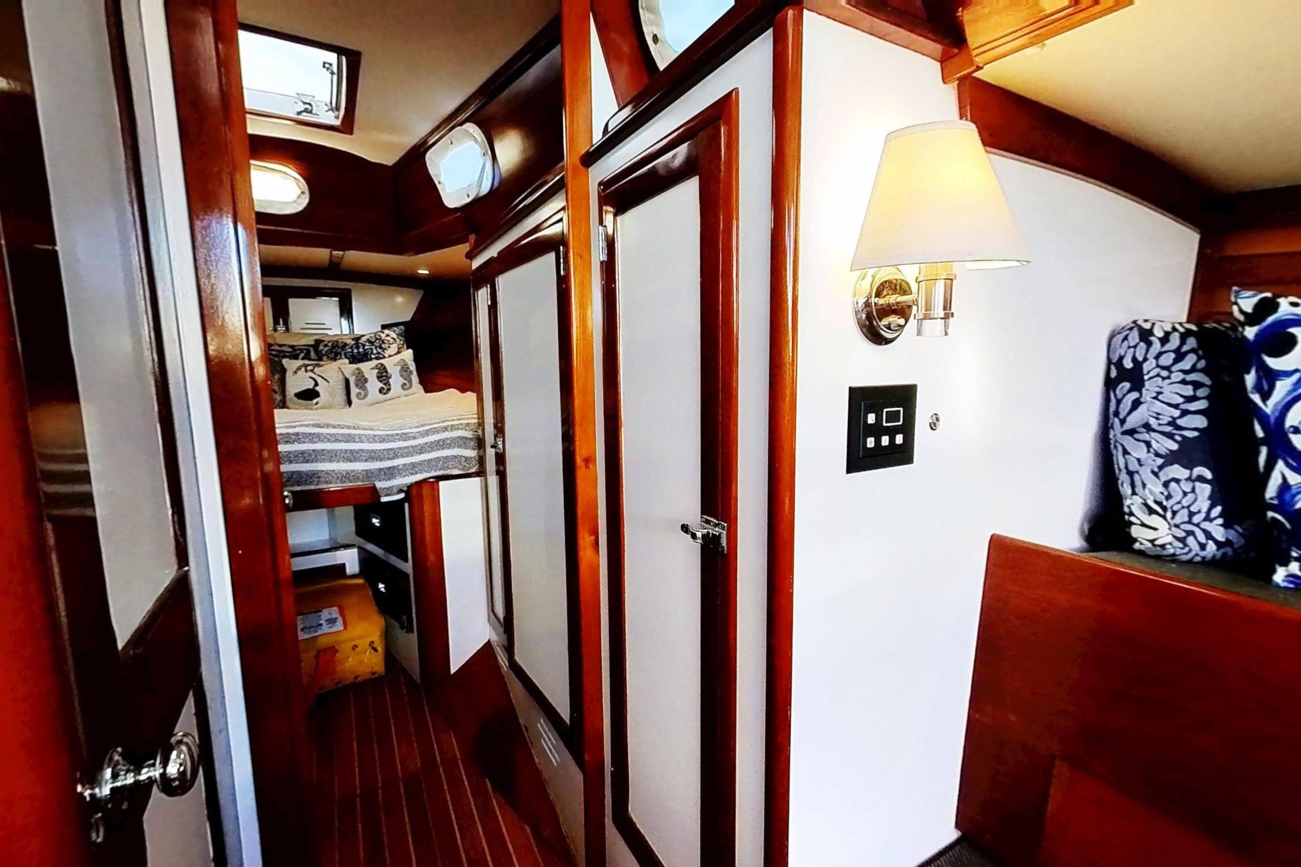 Interior of a 1970 Hinckley Bermuda 40 sailboat, featuring cozy wooden cabin and nautical decor.