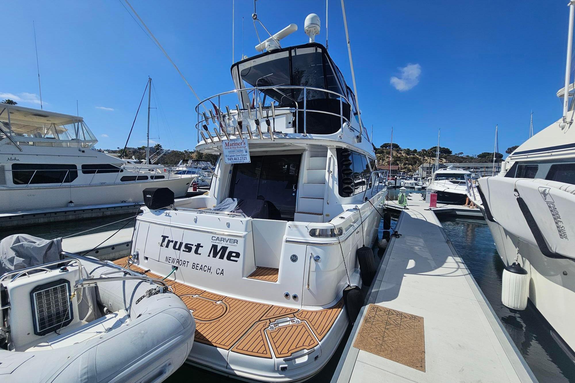 2002 Carver 450 Voyager Pilothouse yacht docked at marina, Newport Beach, CA.