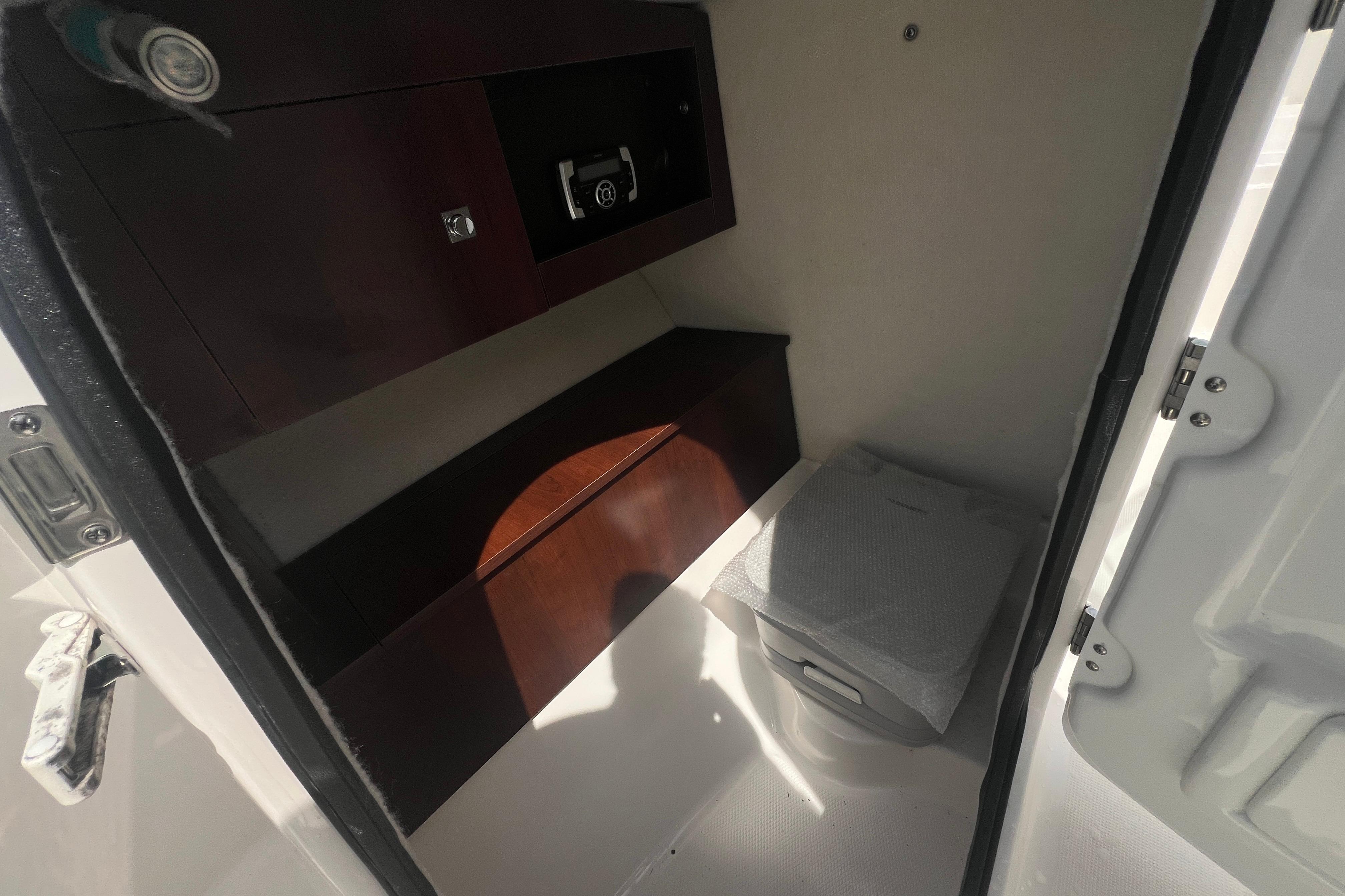 Interior cabin of 2022 Robalo R227 Dual Console boat with storage and seating.