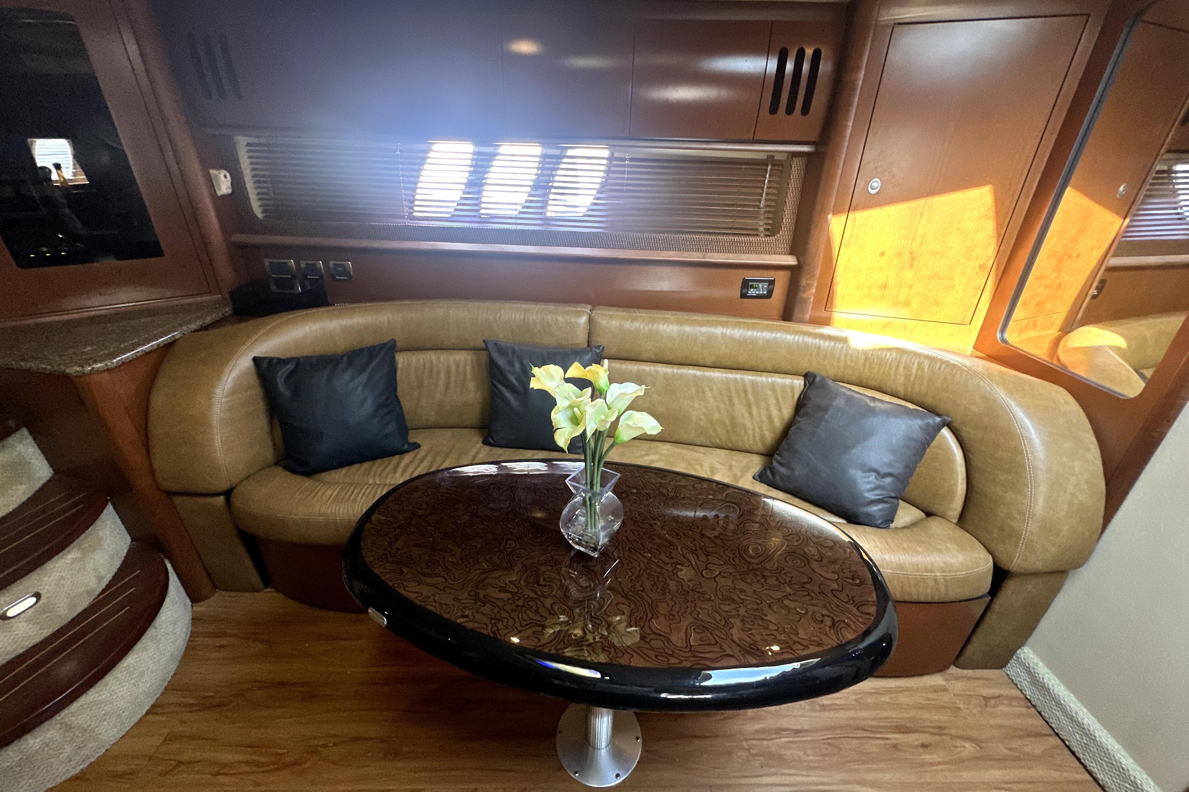 Luxurious interior of 2007 Sea Ray 44 Sundancer with elegant seating and table.
