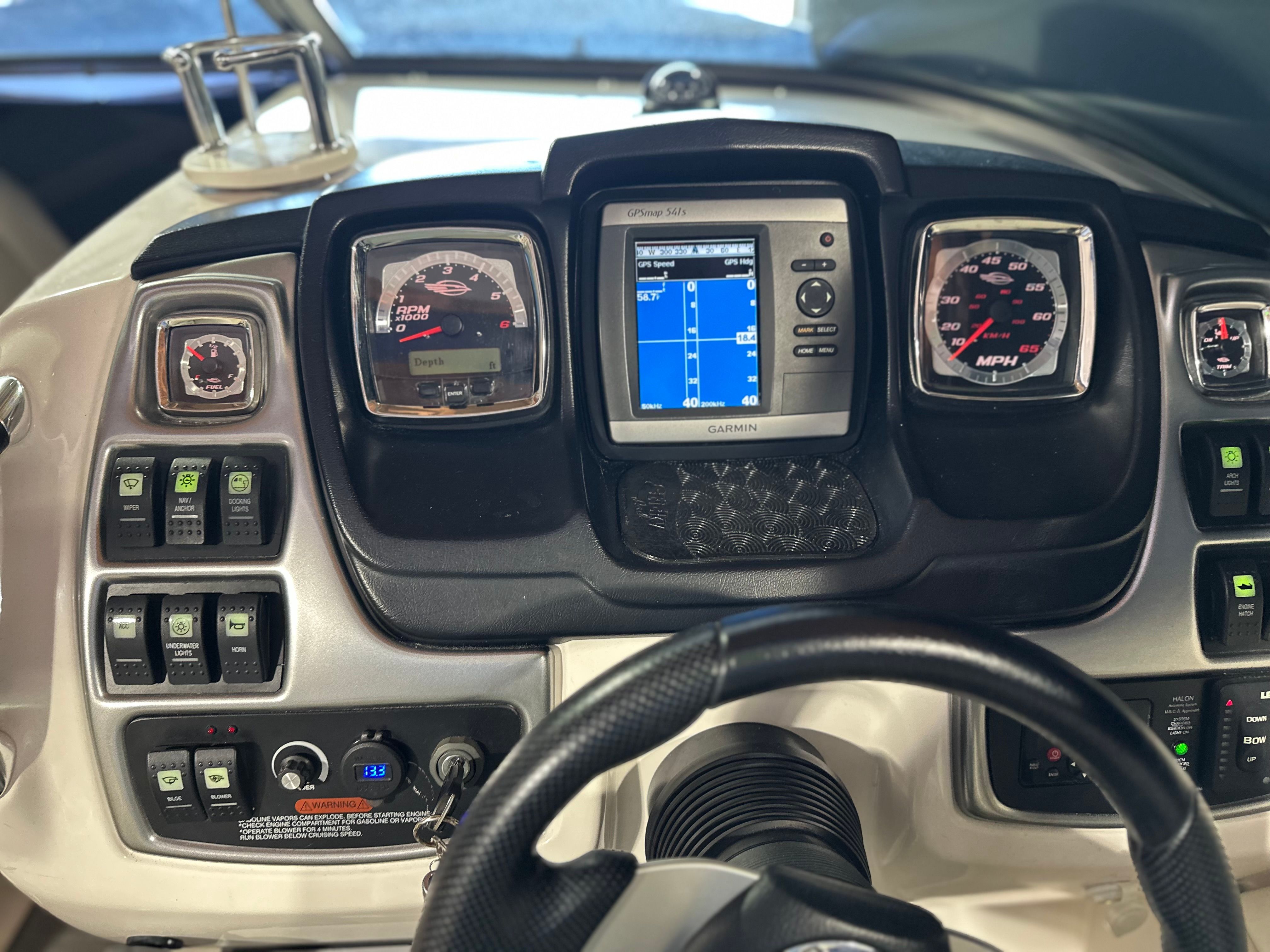 The dashboard of a 2011 Chaparral 287 SSX with various gauges and a Garmin navigation system.