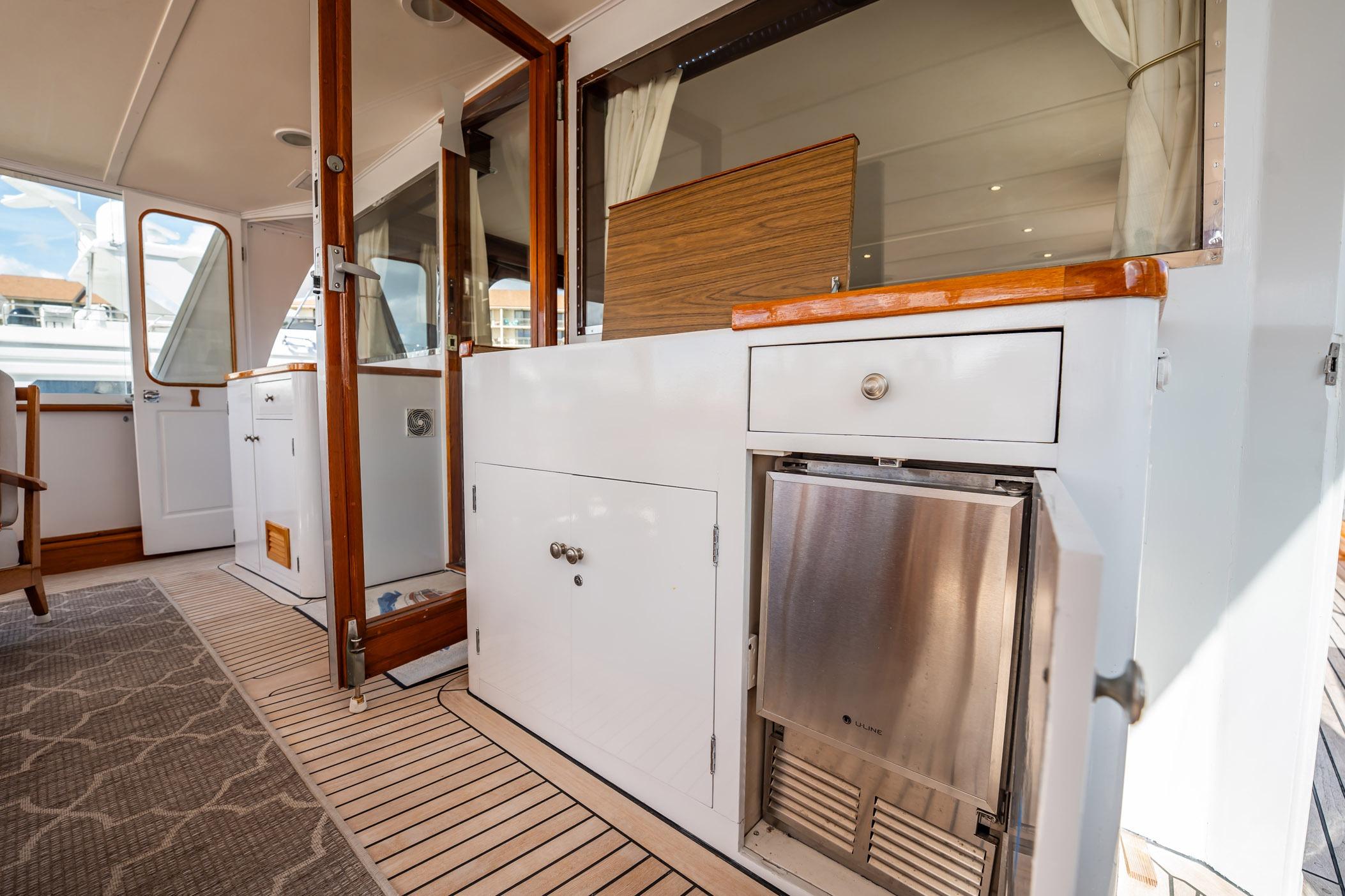 Interior view of a 1972 Trumpy 72 Motor Yacht, featuring wooden accents and modern amenities.
