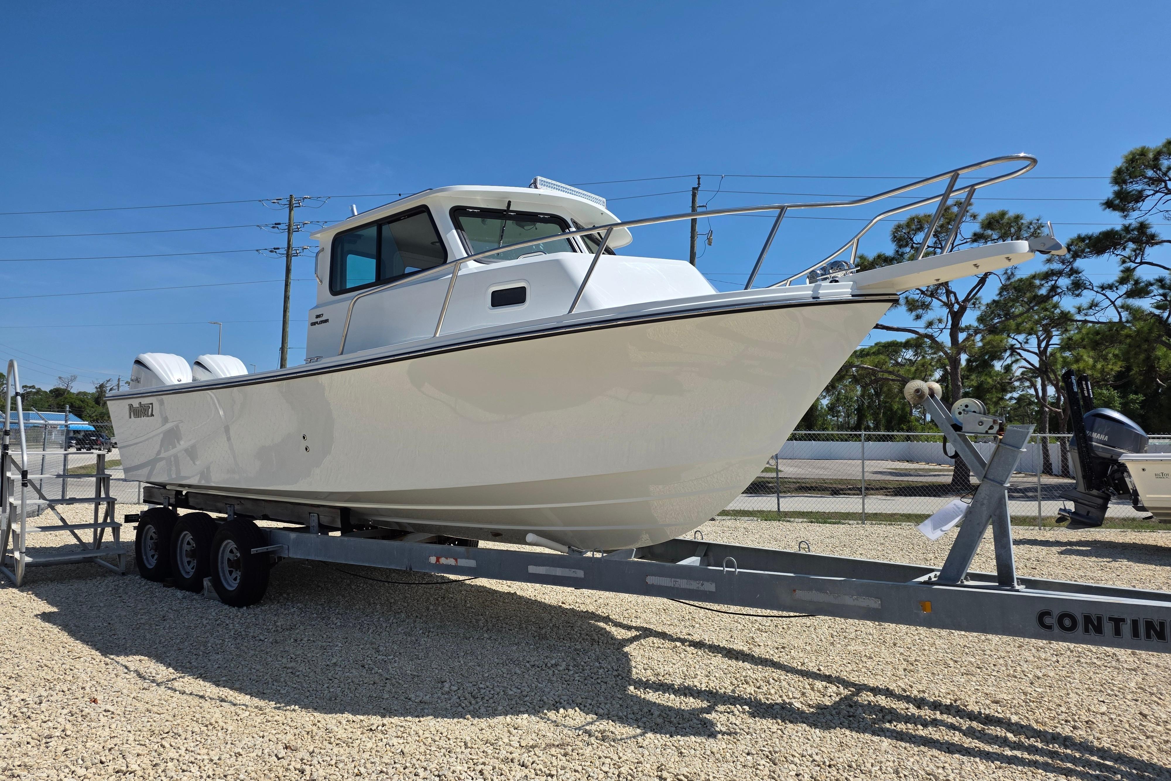 2026 Parker 287 Explorer boat on trailer, displayed outdoors under clear blue sky.