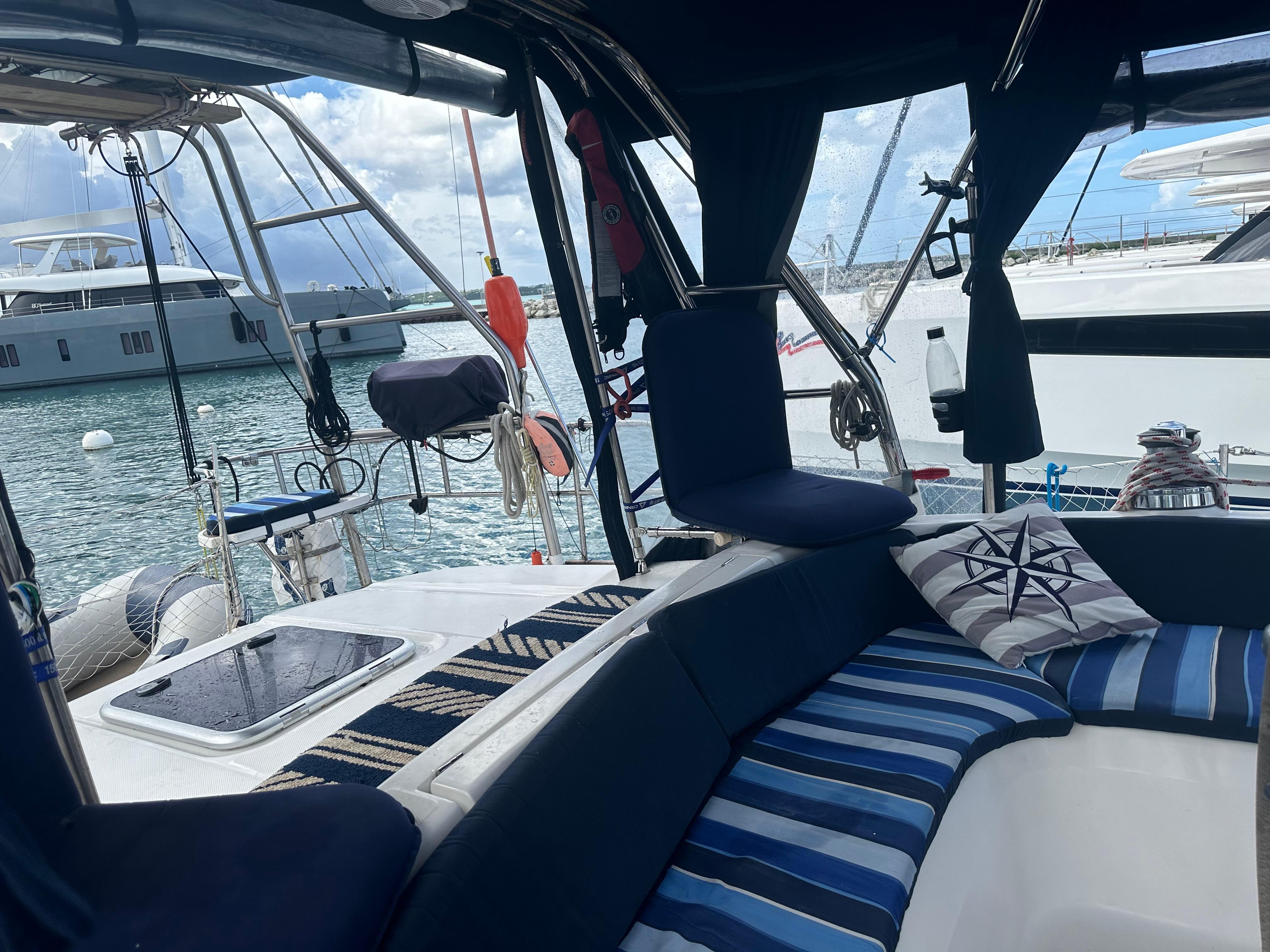 Interior of a 2006 Hunter 45cc yacht with striped cushions and marina view.