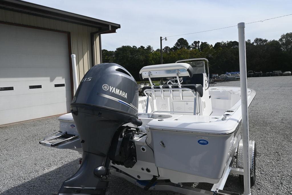 2026 Tidewater 1910 Bay Max boat with Yamaha engine, parked on gravel near a building.
