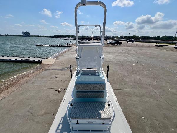 2022 Shallow Sport 20 Classic boat on a concrete dock by the water.
