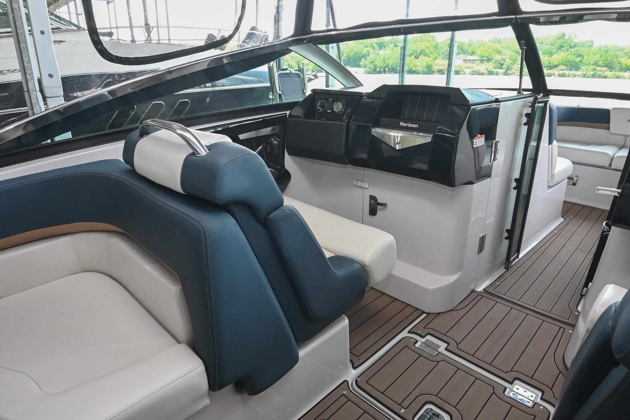 Interior of 2014 Four Winns H290 boat with sleek seating and modern dashboard design.