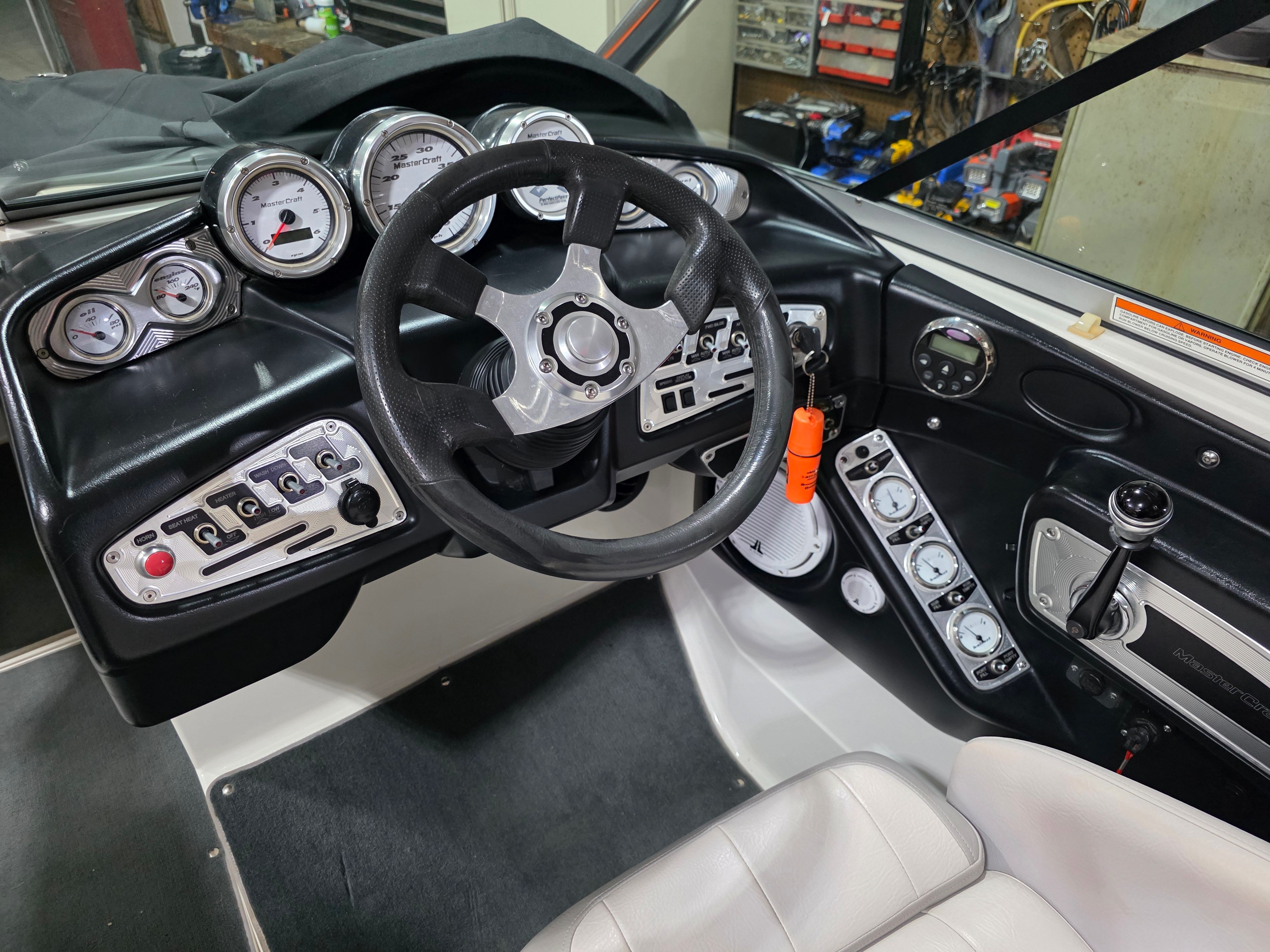 Interior view of 2007 MasterCraft X-15 boat cockpit with steering and gauges.
