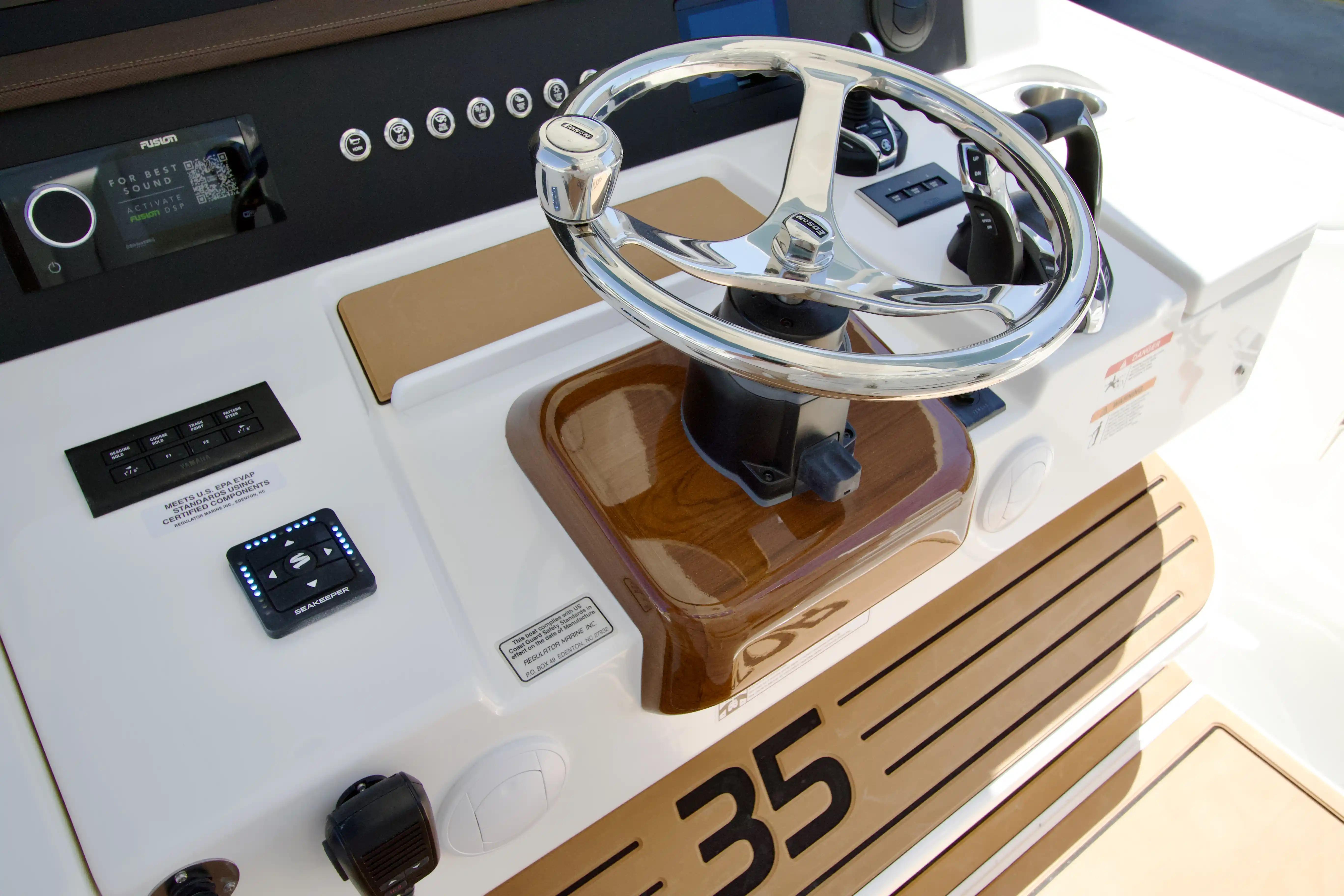 2027 Regulator 35 boat helm with modern controls and sleek steering wheel design.