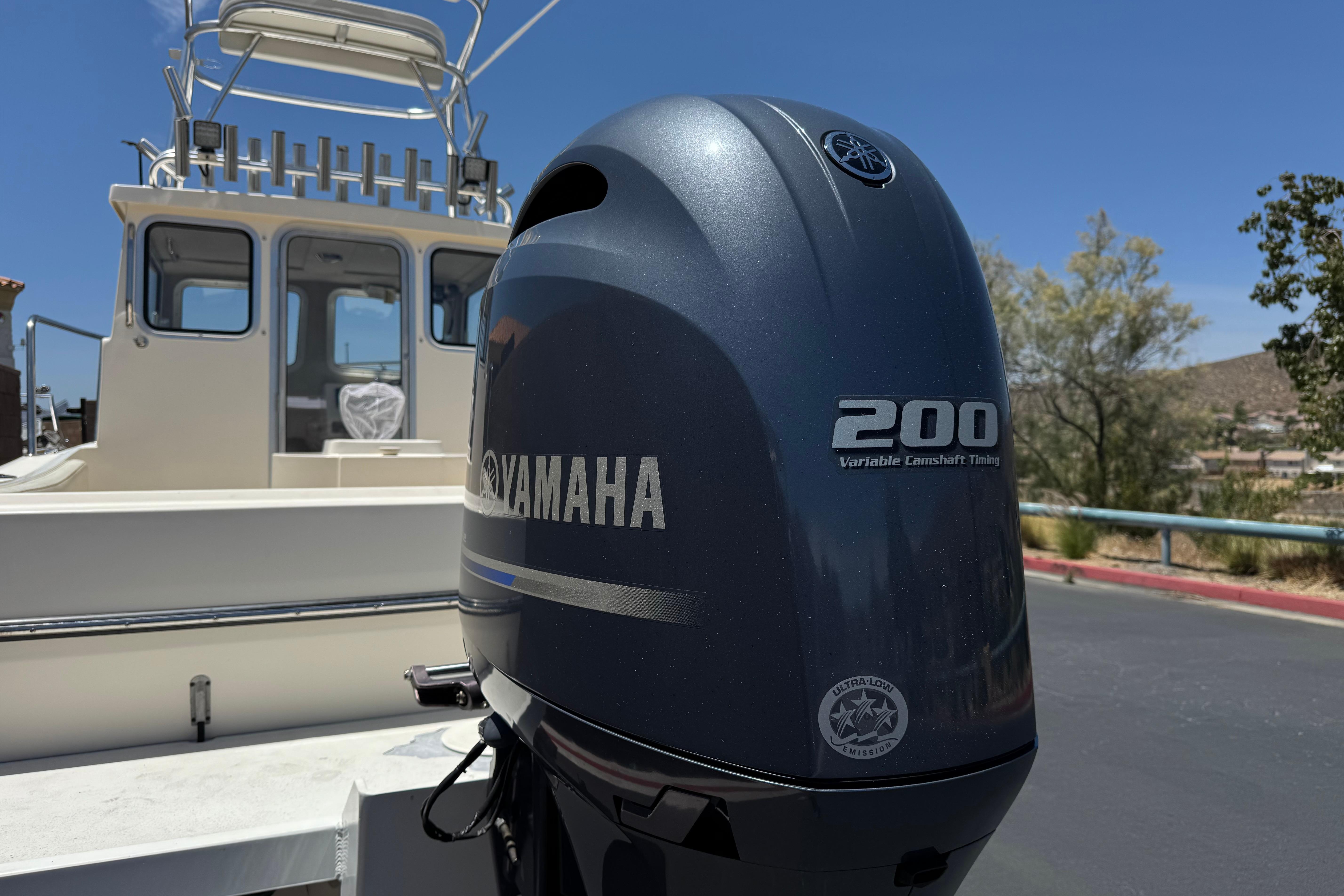 2017 Defiance Admiral 220 EX boat with Yamaha 200 engine, parked outdoors.