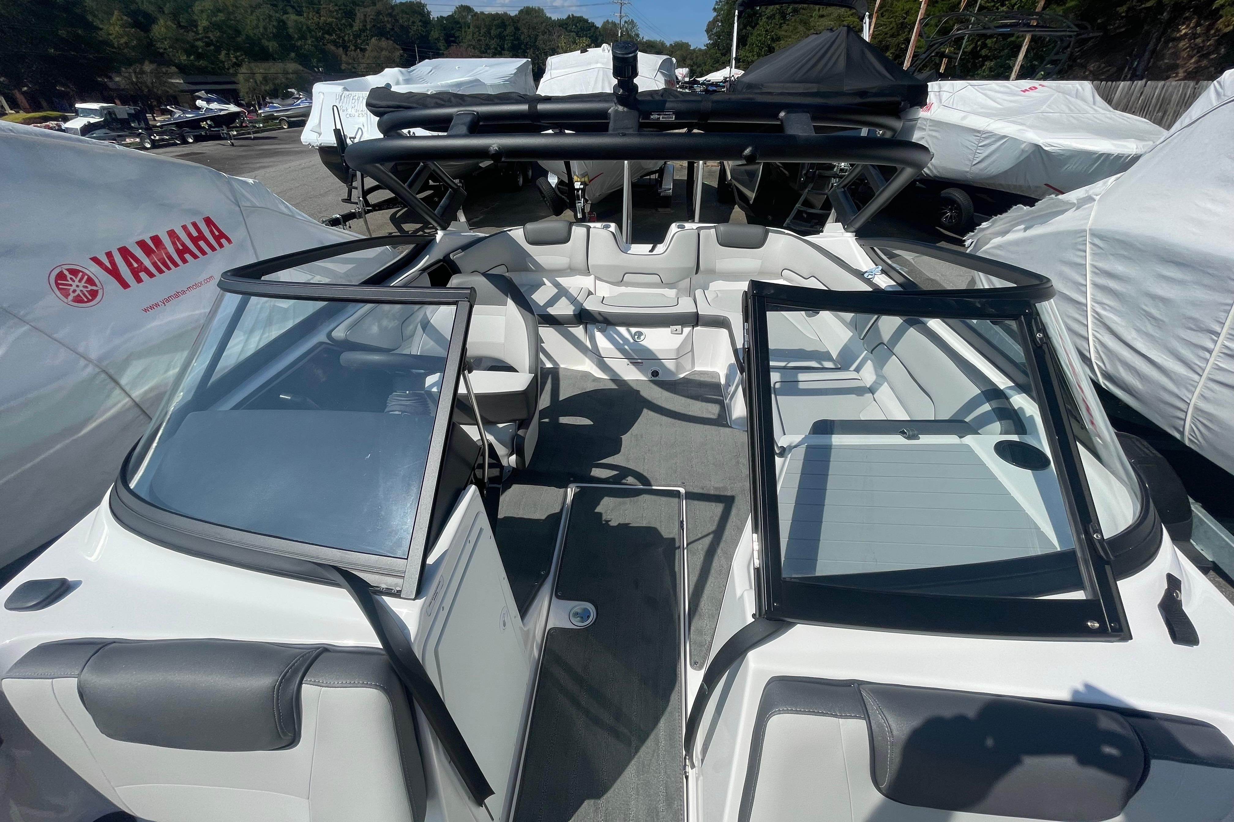 2026 Yamaha Boats AR190 interior with open seating and windshield, displayed outdoors.