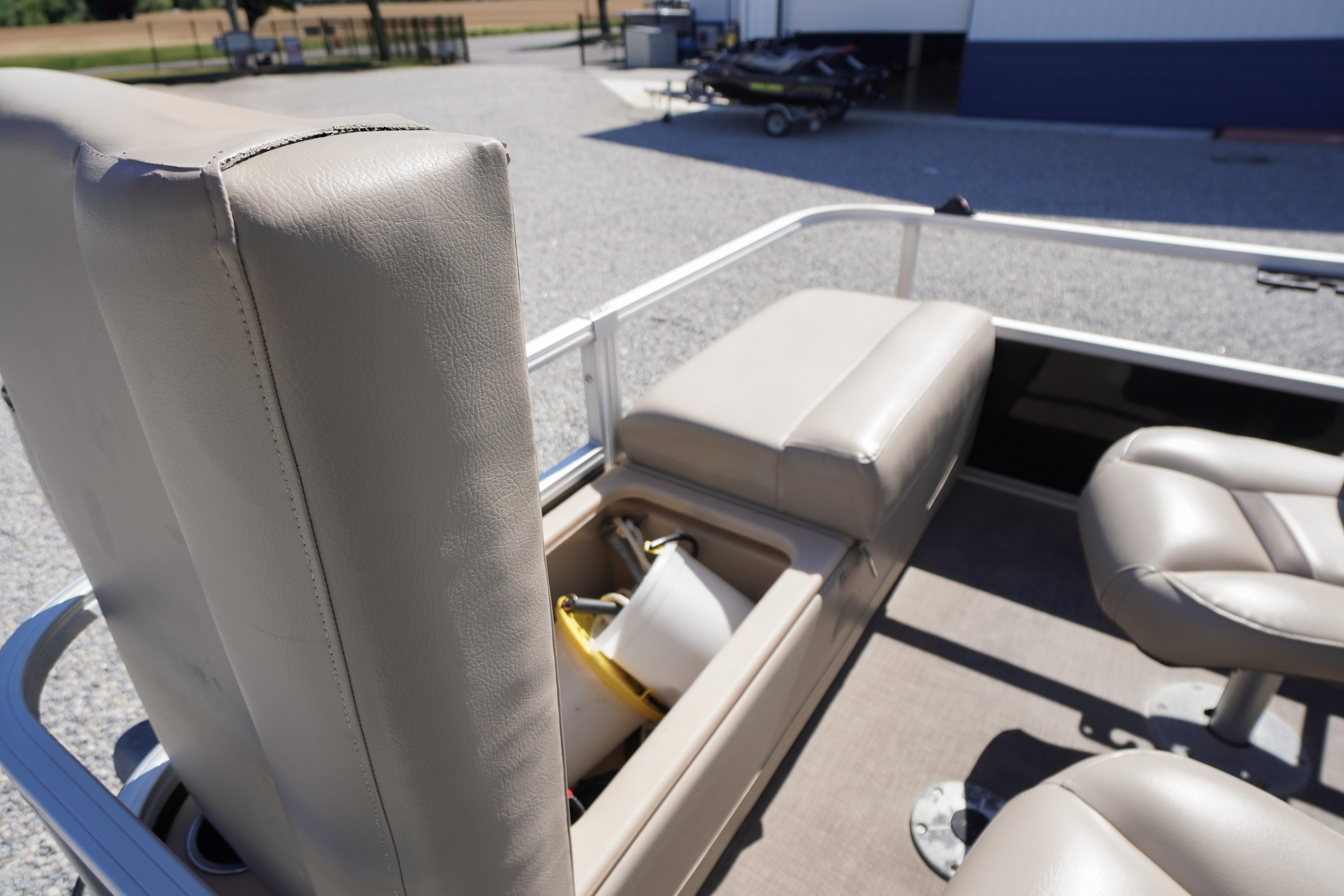 2019 SUNTRACKER Fishin' Barge 22 DLX interior with beige seating and storage compartment.