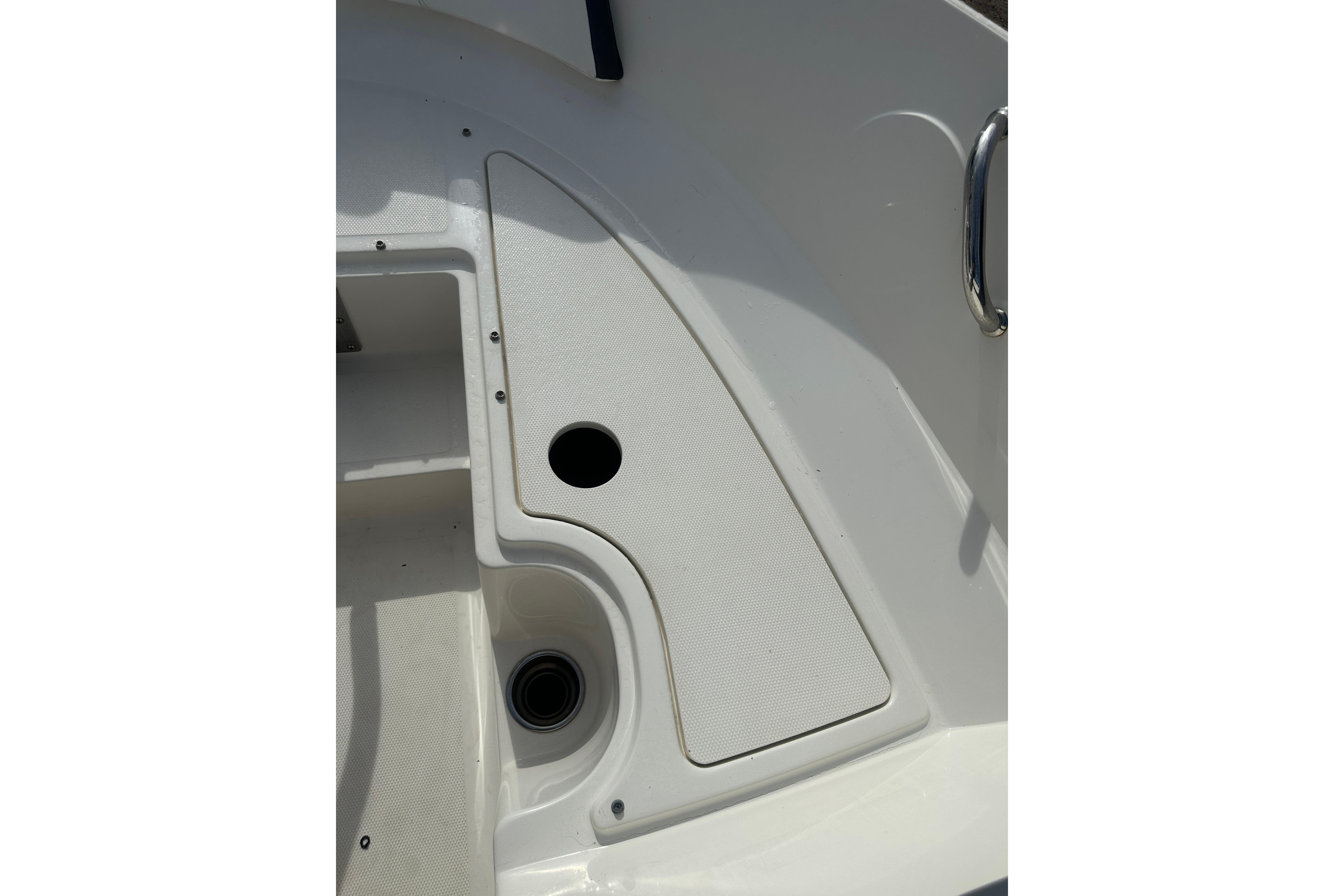 2017 Sea Ray SPX 190 Outboard boat deck with storage compartment and handle.