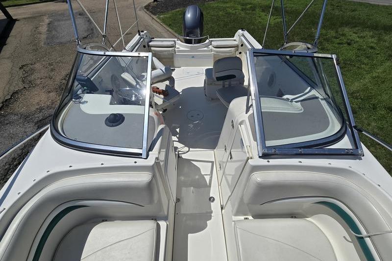 2004 Aquasport 215 Osprey Sport boat interior with seating and windshield.