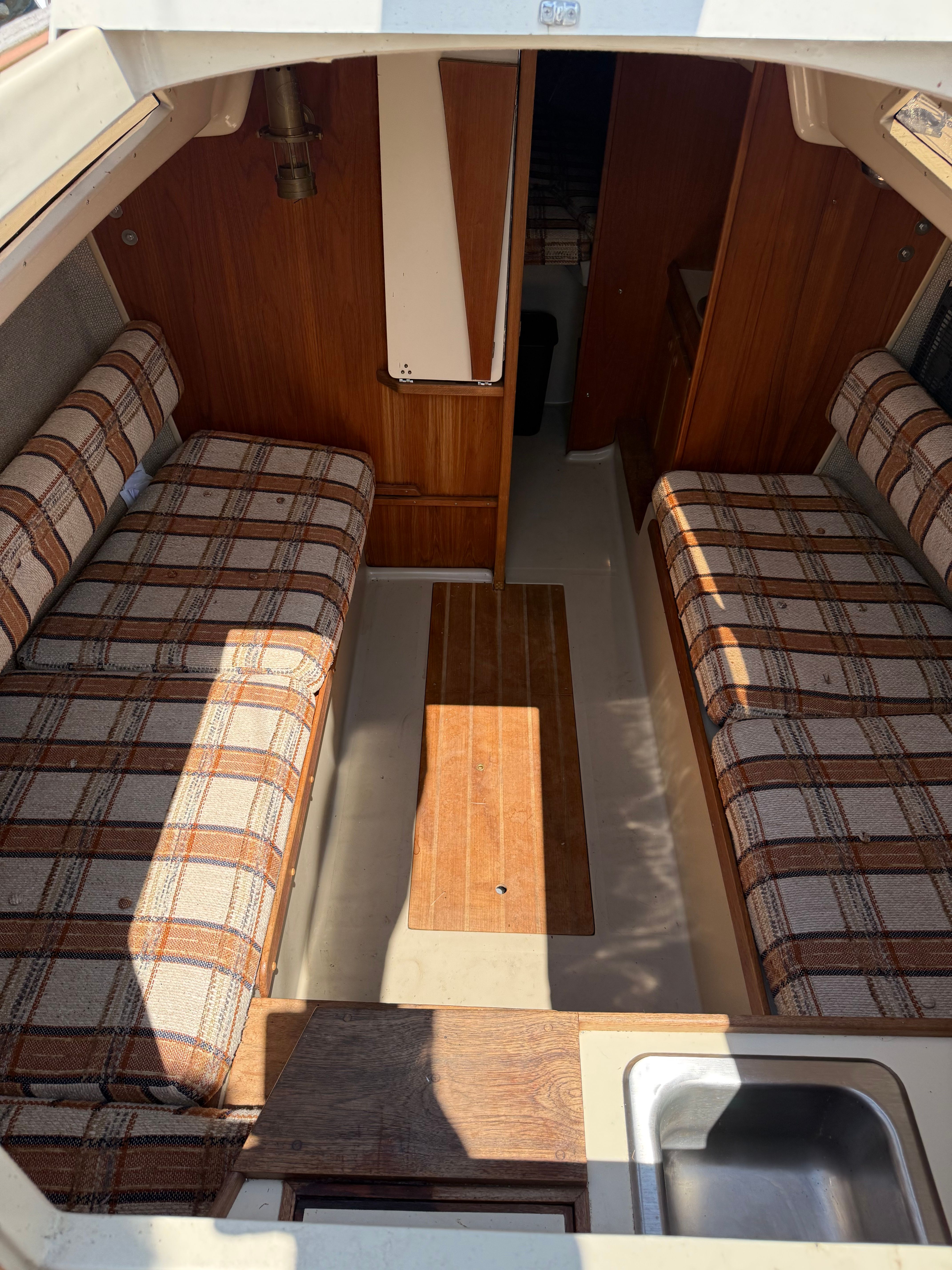 Interior of a 1984 O'Day 25 yacht with cushioned seating.