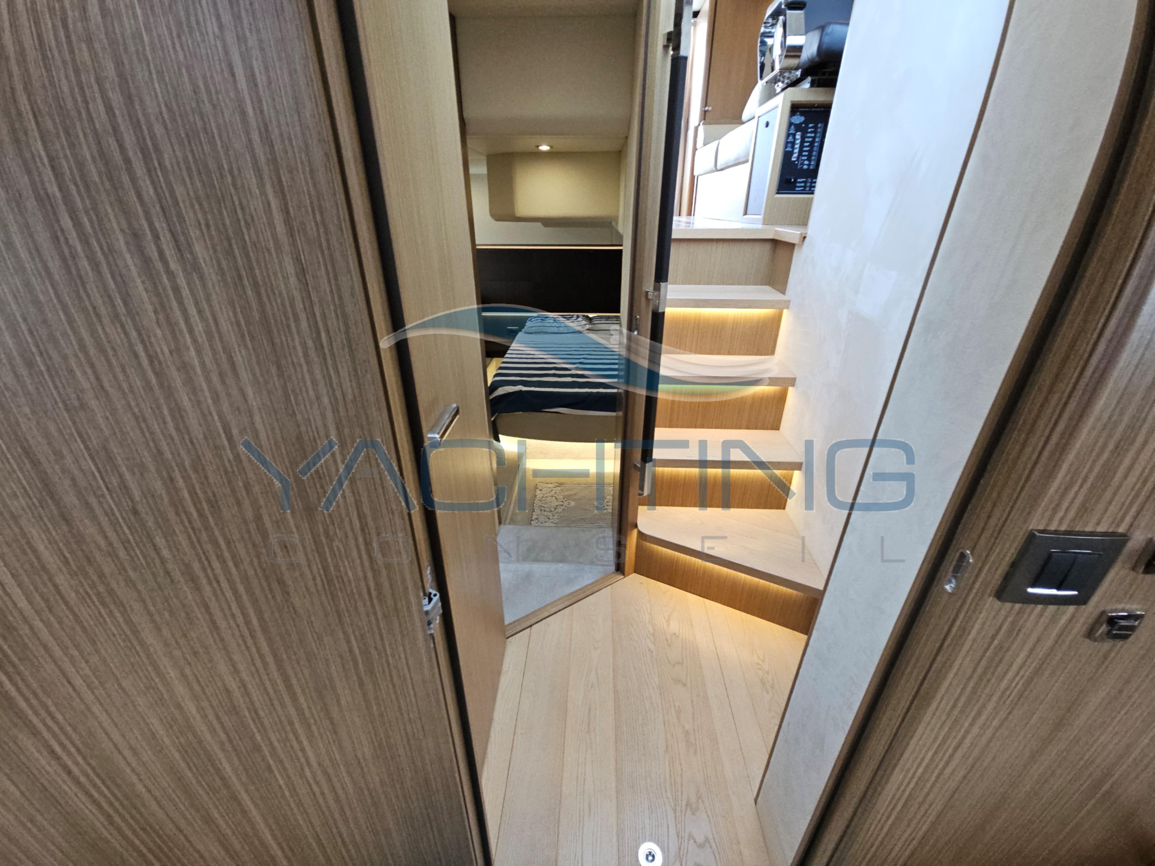 Interior view of 2018 Absolute 45 FLY yacht with wooden finishes and illuminated stairs.