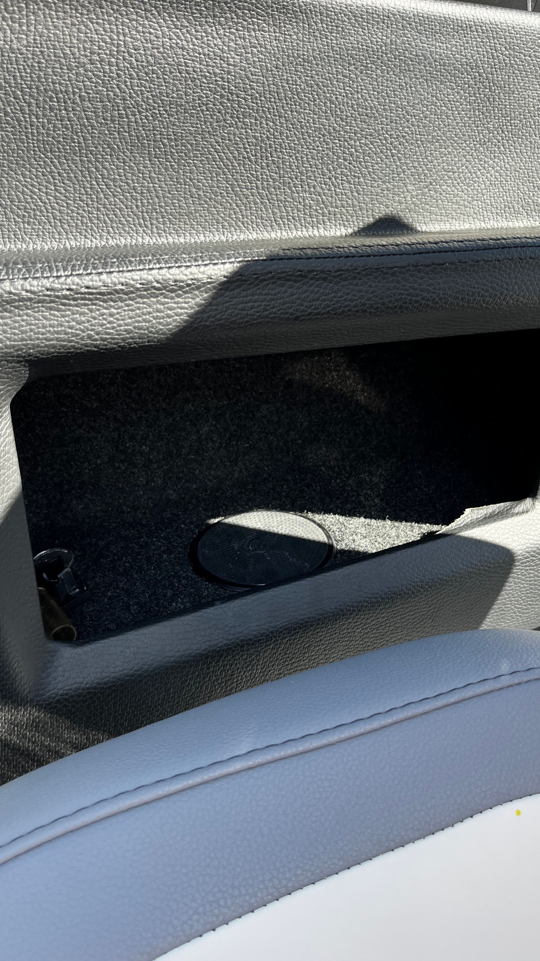 Close-up of a storage compartment with gray upholstery in the Malibu Wakesetter 26 LSV.