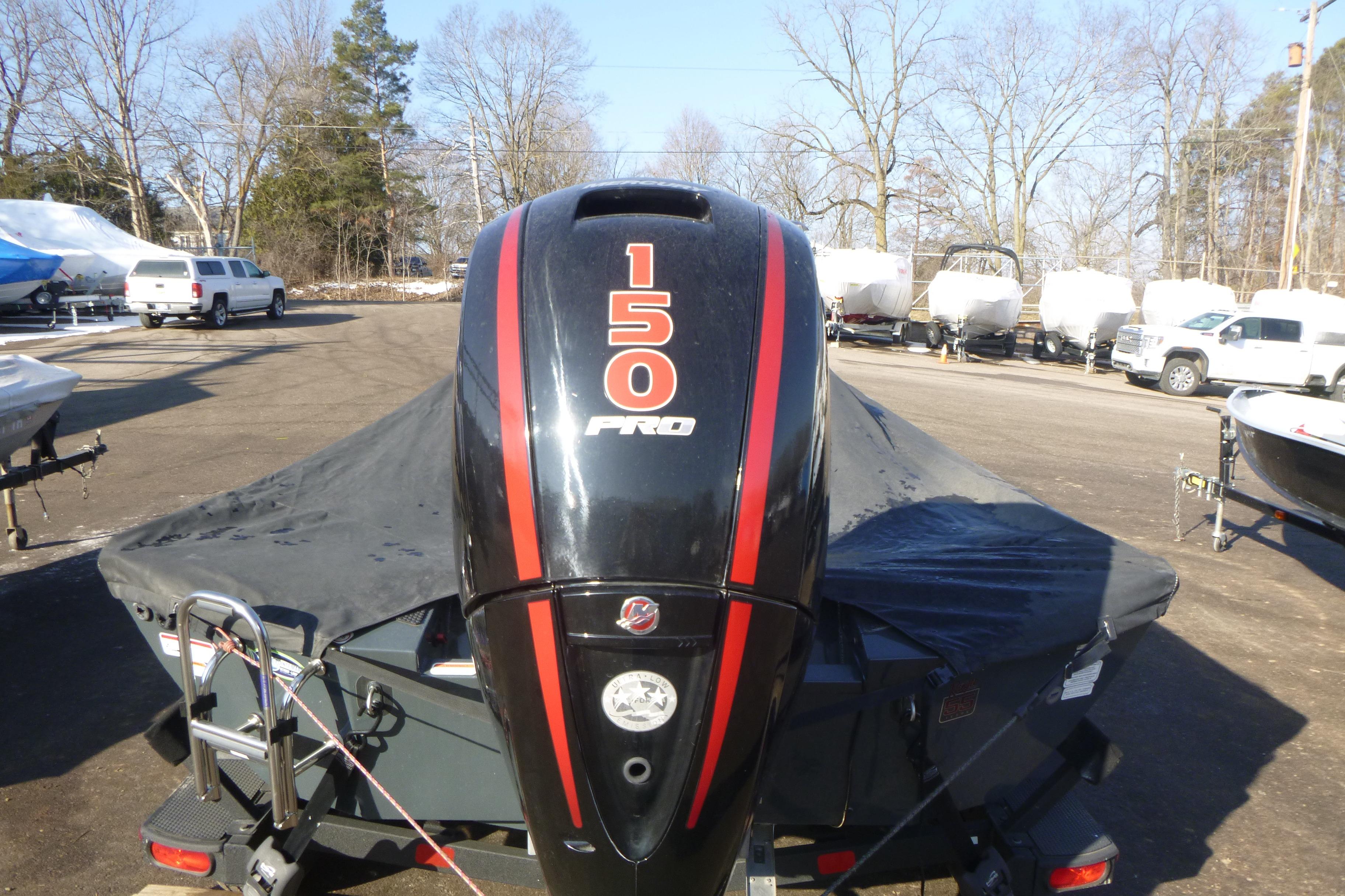 2023 Ranger RT198P boat with 150 Pro engine, covered and parked outdoors.