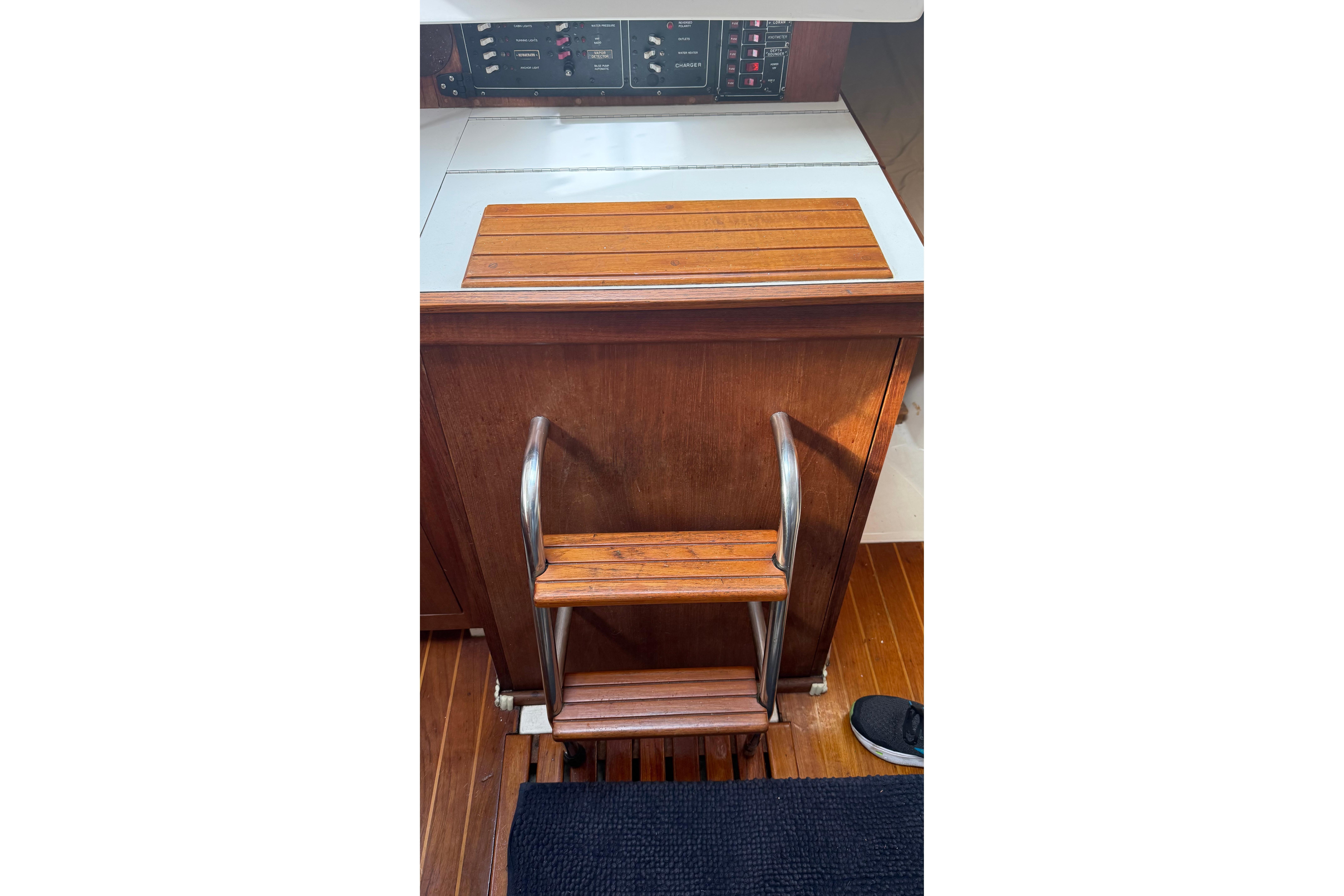Wooden interior steps and paneling on a 1984 Hunter 31 sailboat.