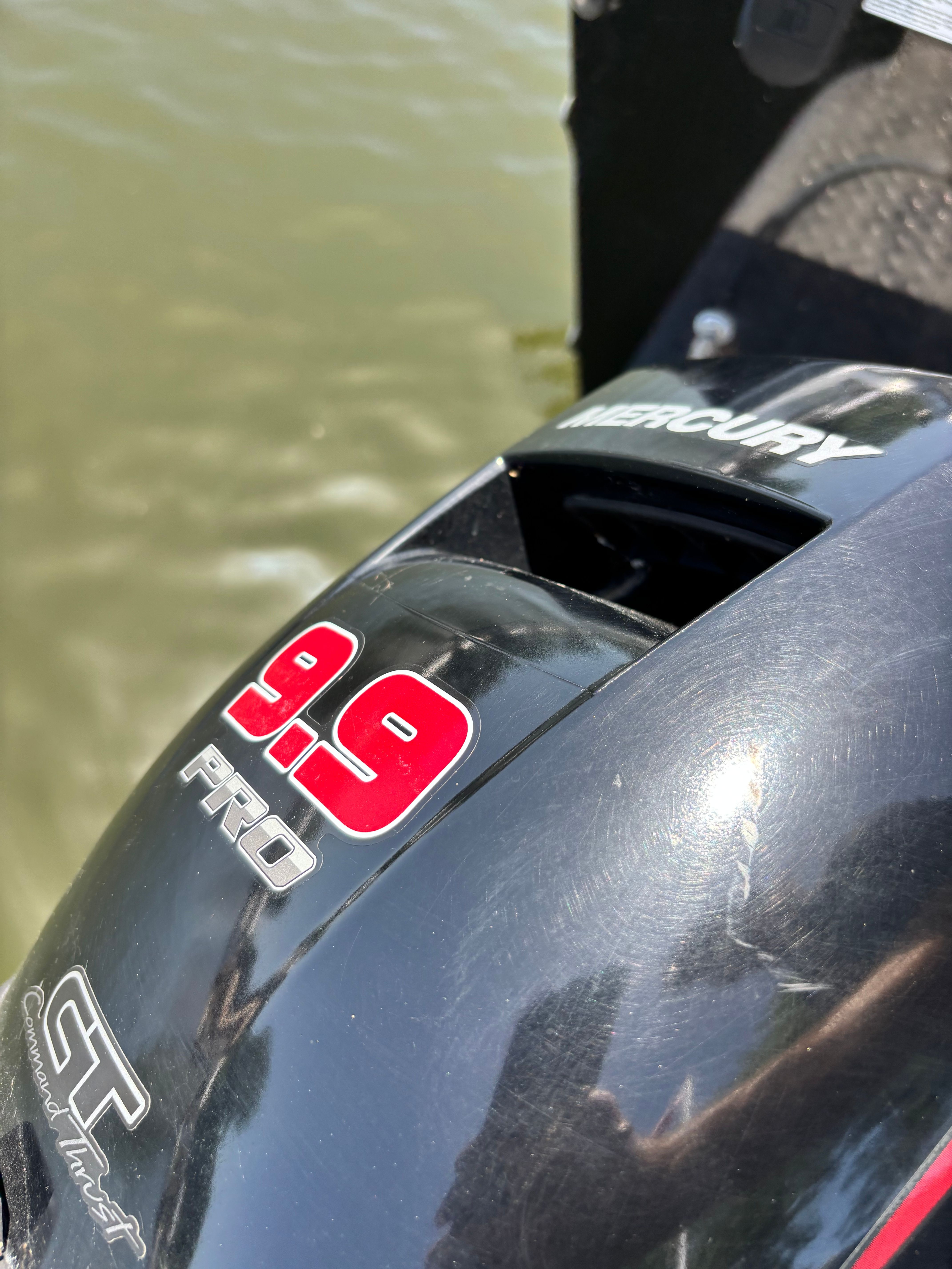 Close-up of a Mercury 9.9 HP outboard motor on a boat.