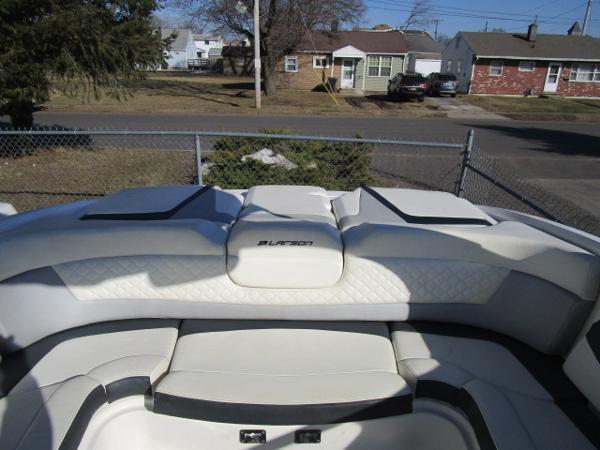 2017 Larson 292 LXI boat interior with white seating in a residential area.