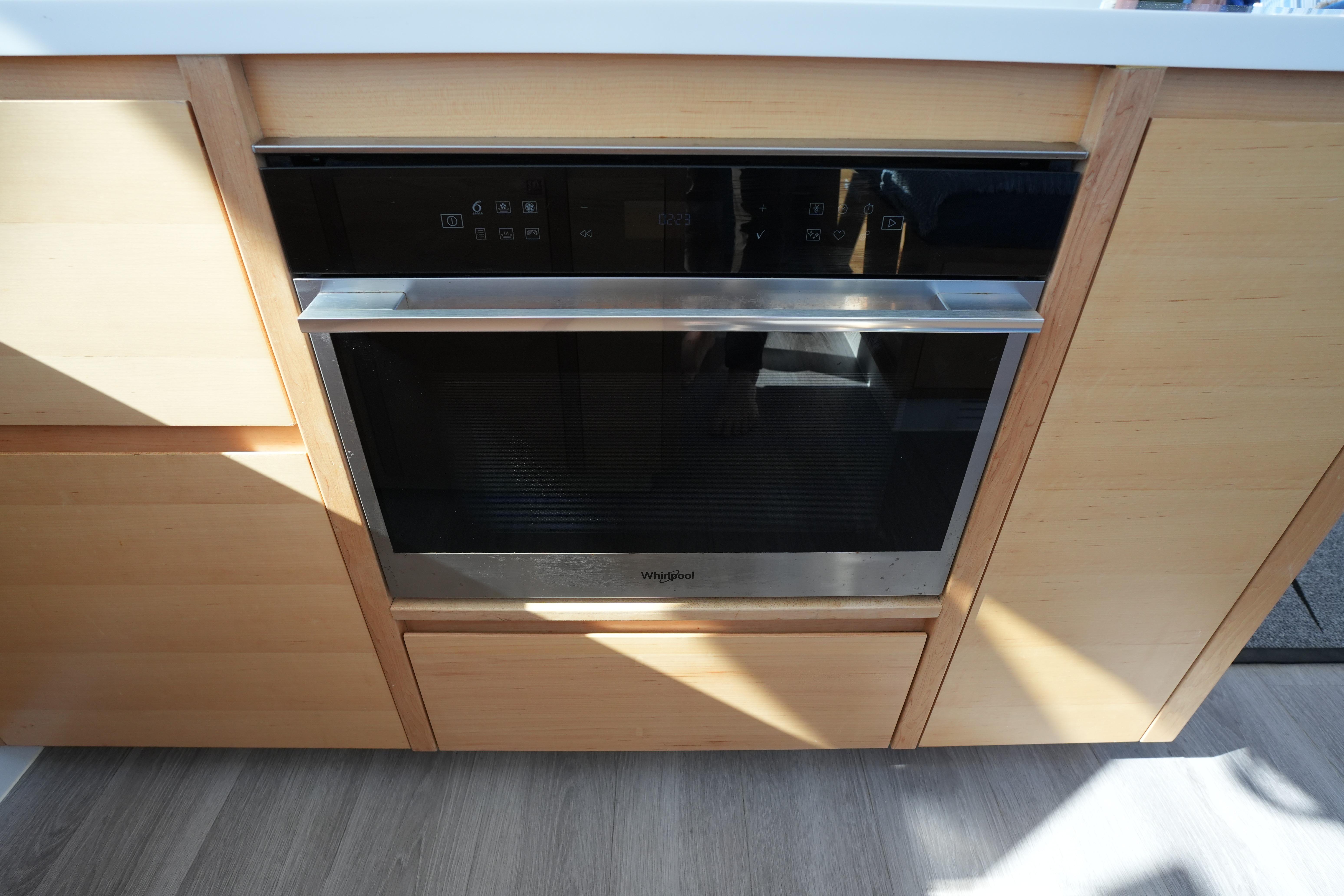 Modern kitchen oven with sleek design, integrated into wooden cabinetry, Balance 442 model, 2024.