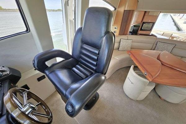 Luxurious interior of 2005 Sunseeker Manhattan 66 yacht with leather captain's chair.