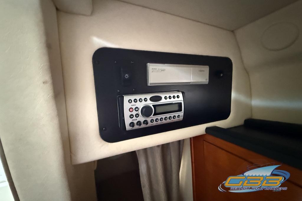 2006 Sea Ray Sundancer 260 cabin stereo system with control panel and storage.