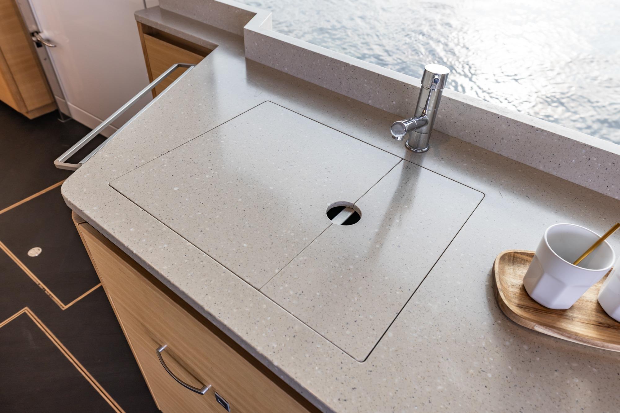 Modern kitchen sink area on 2017 Steeler Panorama FF 53 yacht with sleek countertop design.