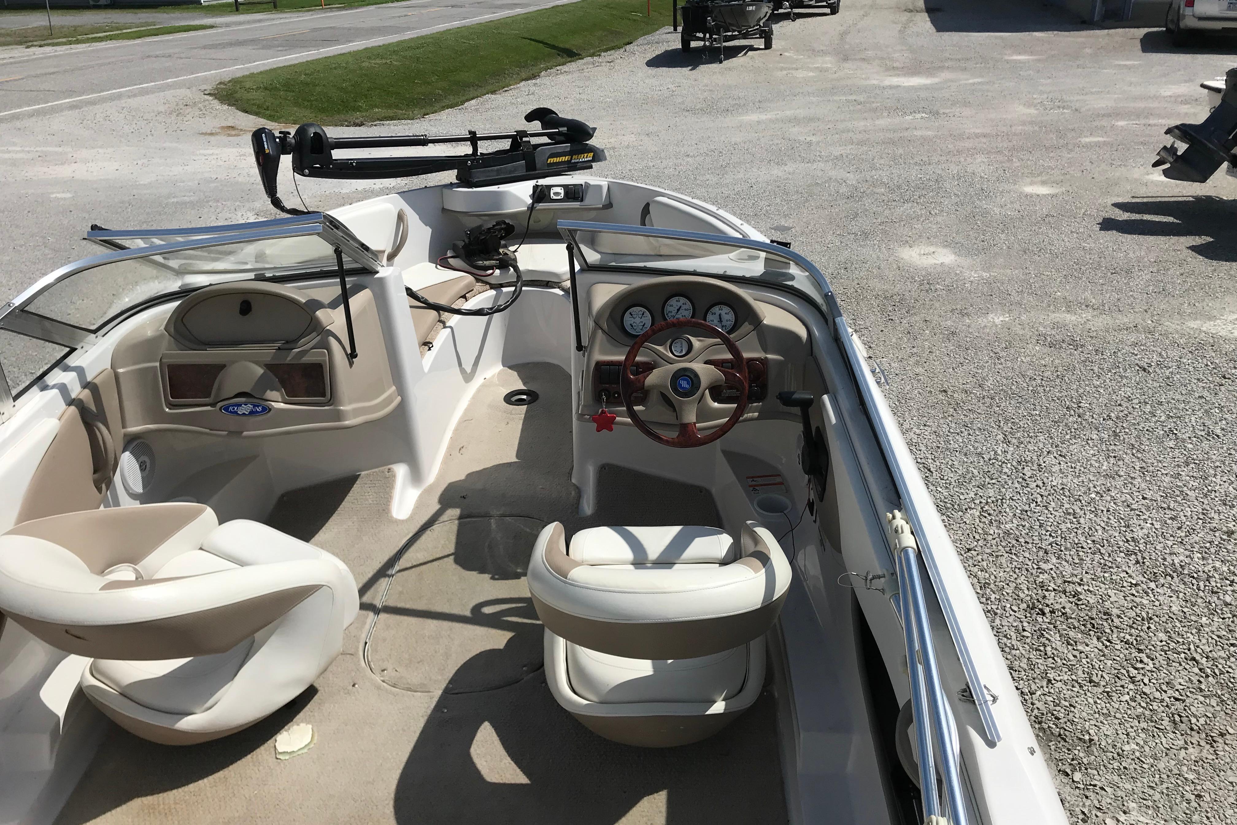2005 Four Winns 180 Horizon FS boat interior with steering wheel and seating.