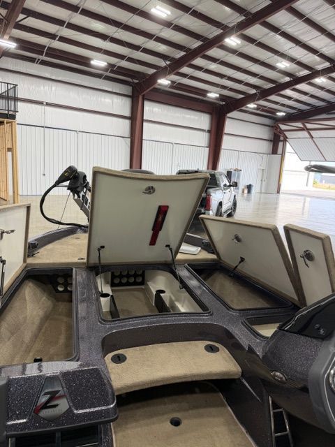 2011 Ranger Z520 Comanche boat with open storage compartments in warehouse.