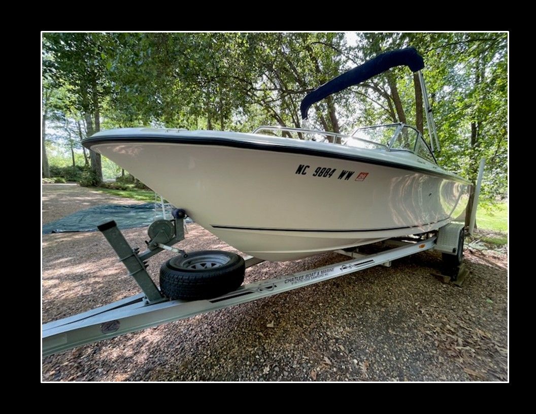 A 2004 Sea Hunt Escape boat on a trailer outdoors.