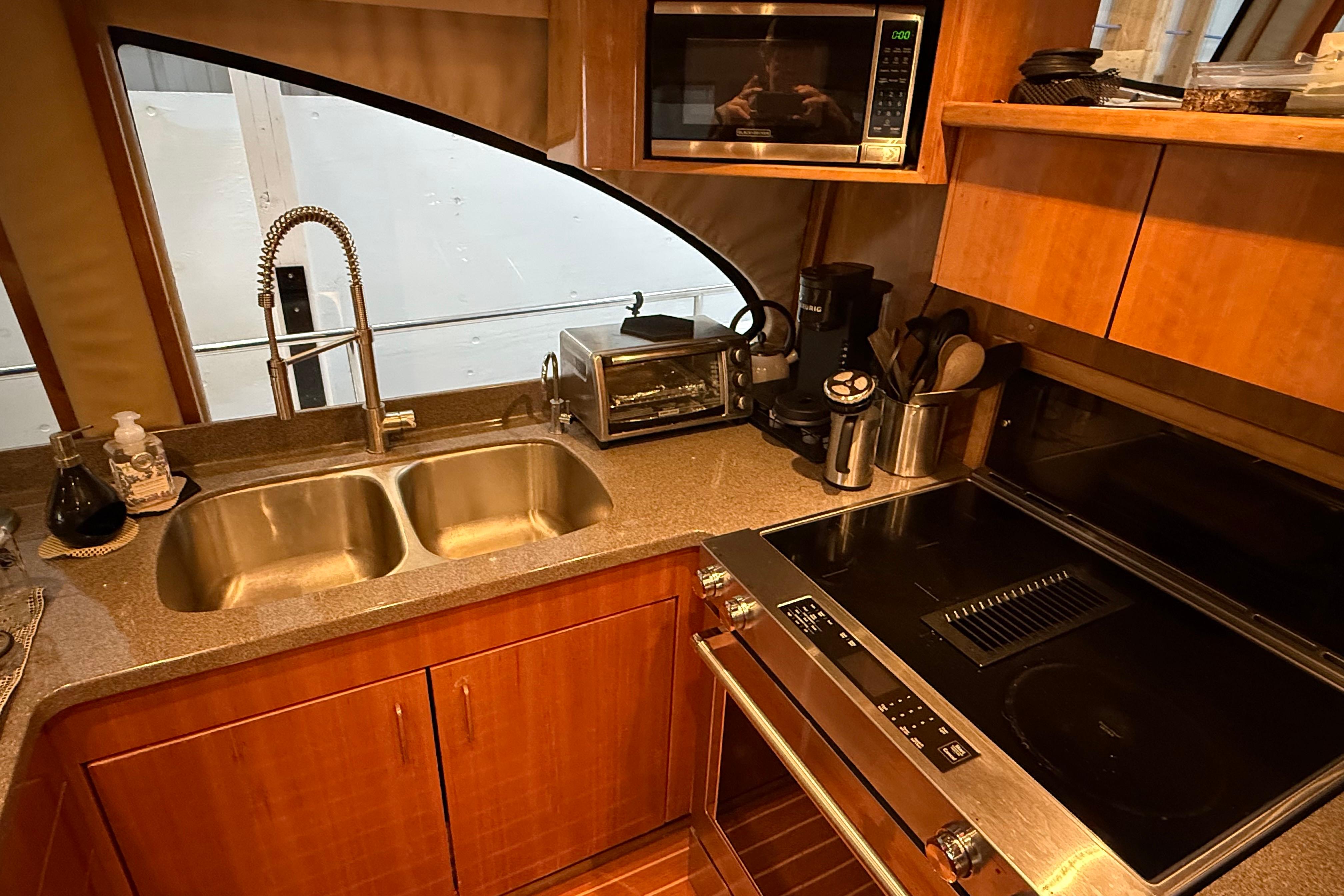 Modern kitchen in 2000 Northern Pacific Motor Yacht with appliances and double sink.