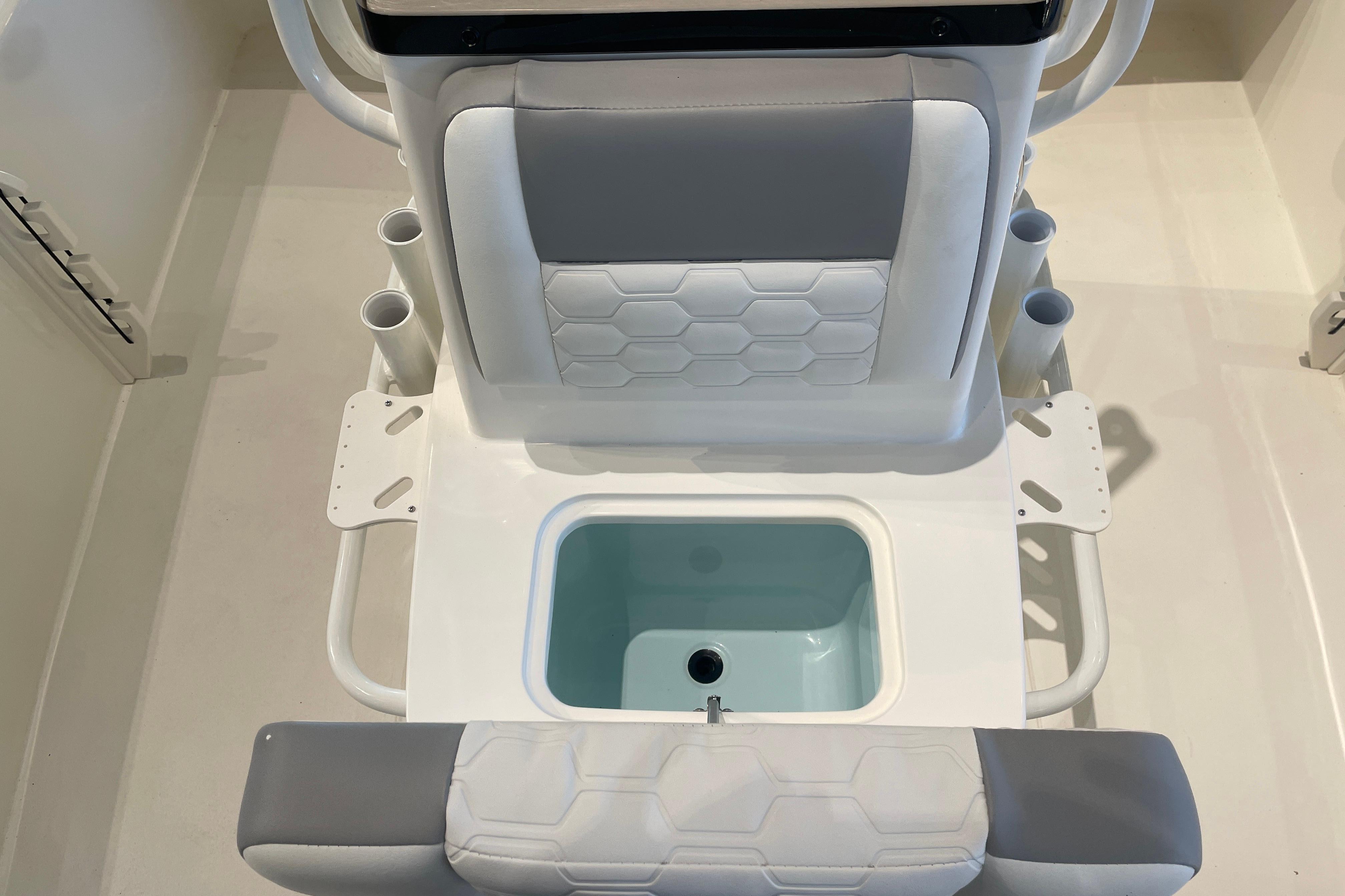 2026 Mako 18 Pro Skiff boat seat with integrated storage and cup holders.