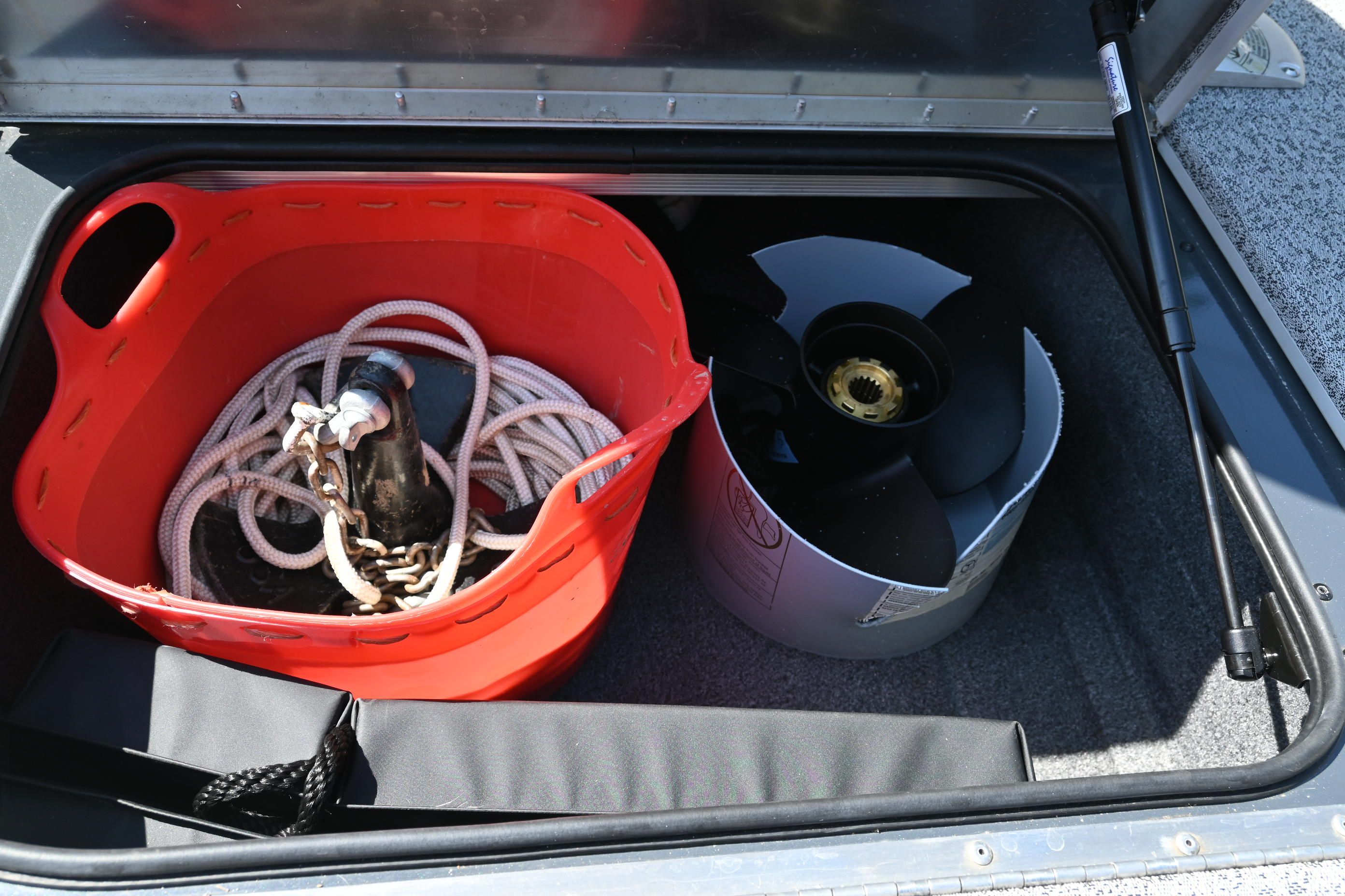 Storage compartment with rope and propeller in a Tracker Pro 175 TF boat.