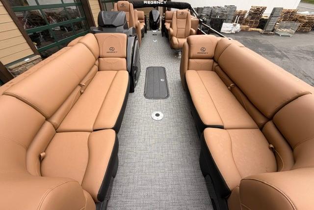Luxurious 2026 Regency 230 DL pontoon boat with spacious tan seating and modern design.