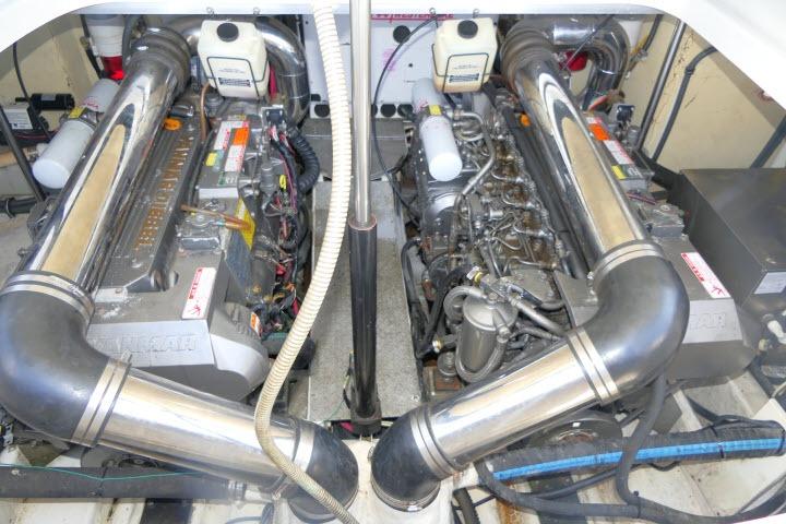 Engine room of a 2003 Thunderbird Formula 40PC boat, showcasing dual engines and exhaust systems.