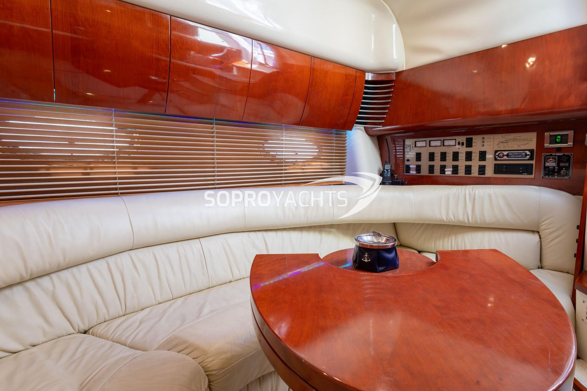 Luxurious interior of 1999 Fairline Targa 43 yacht with leather seating and wooden accents.